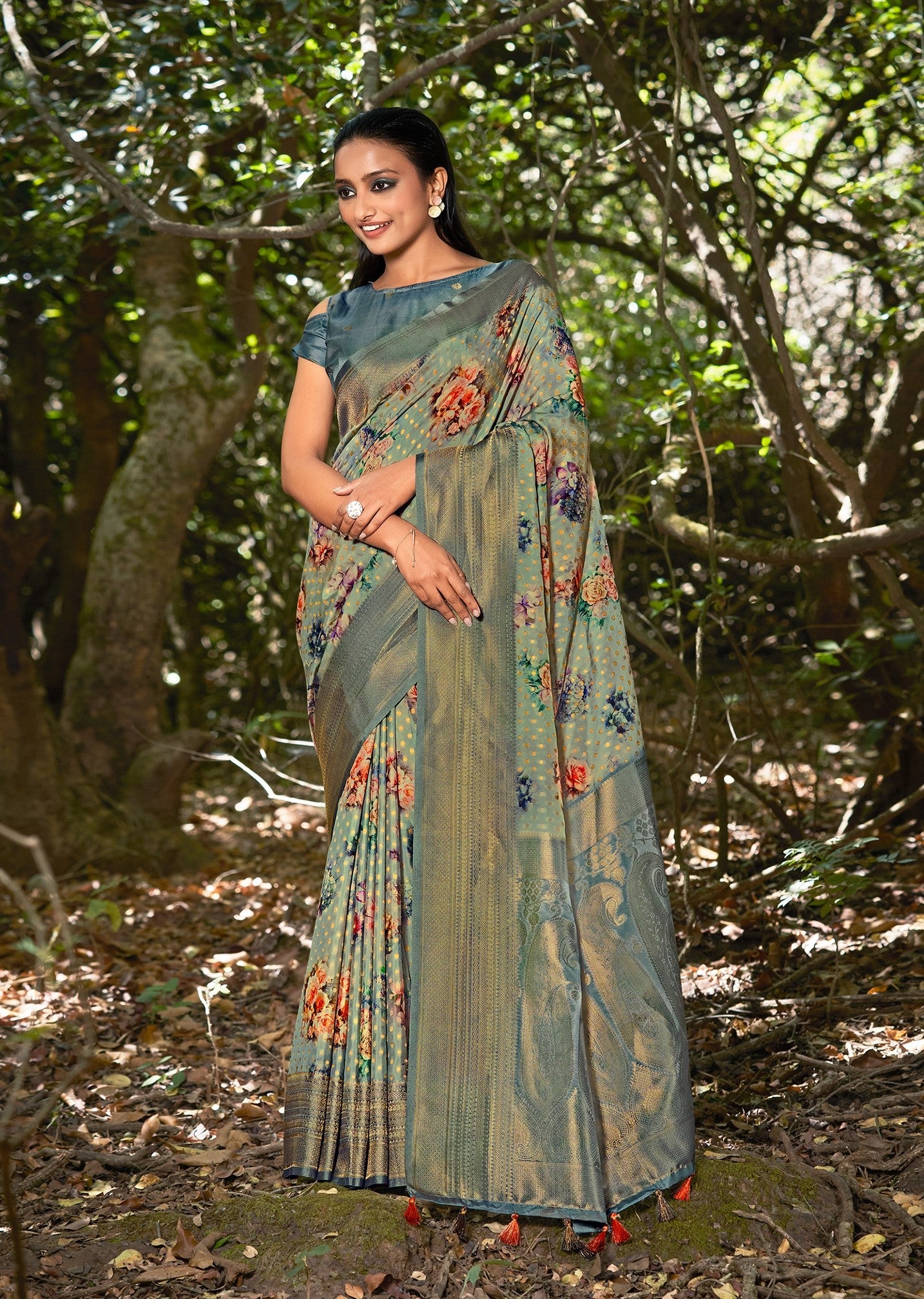 Silk saree in dark blue-green with floral print and woven zari gold border