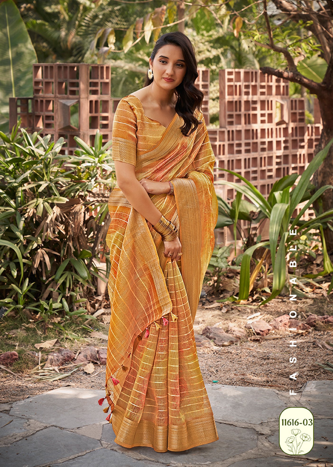 Mustard yellow watercolor linen saree with orange-pink pattern and gold check border, draped