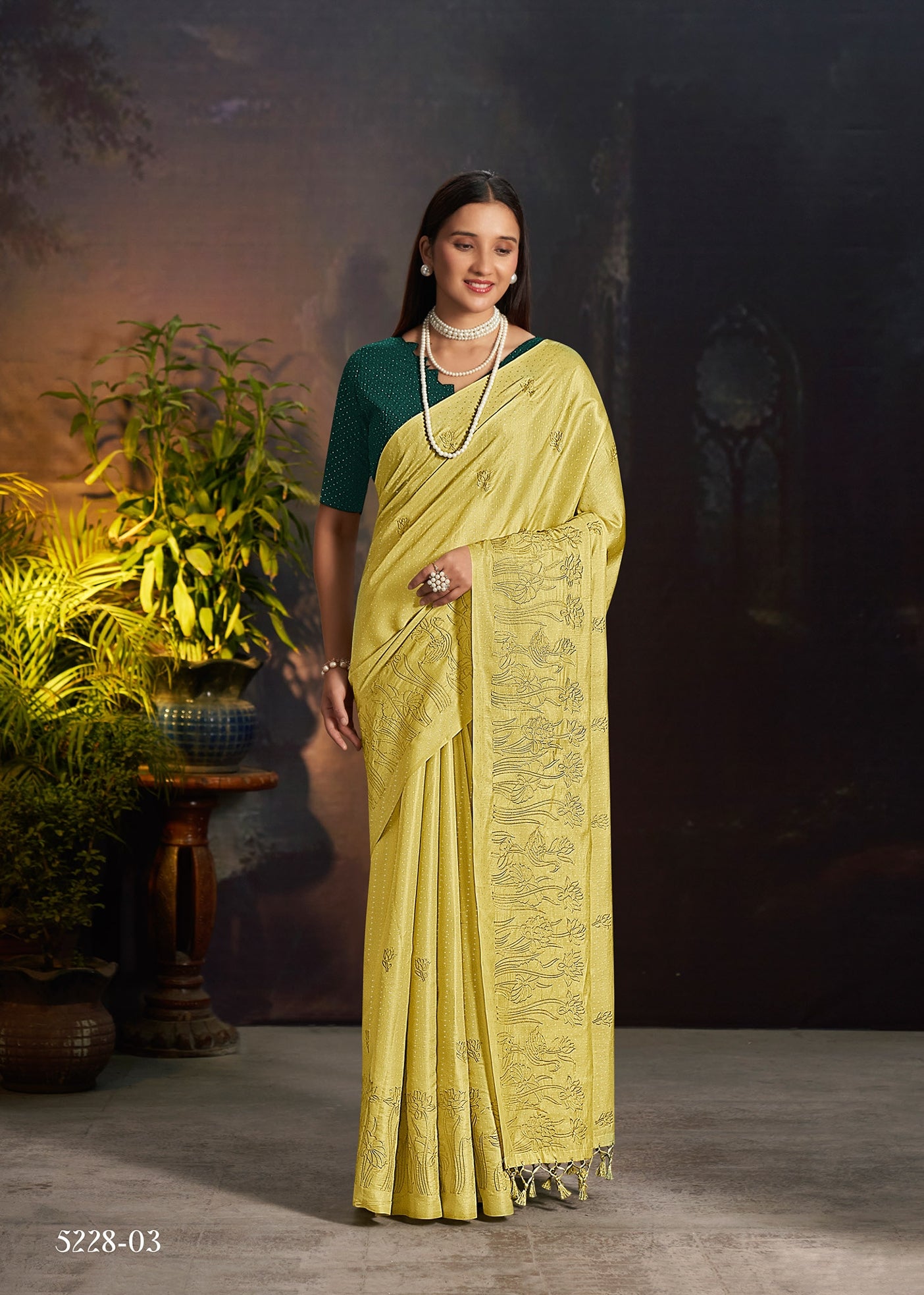 Yellow silk saree with ornate embroidered panels and fringed pallu border