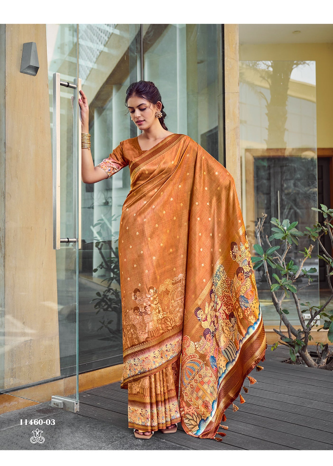 Rust orange silk saree with zari border and Kalamkari mural print, draped pallu