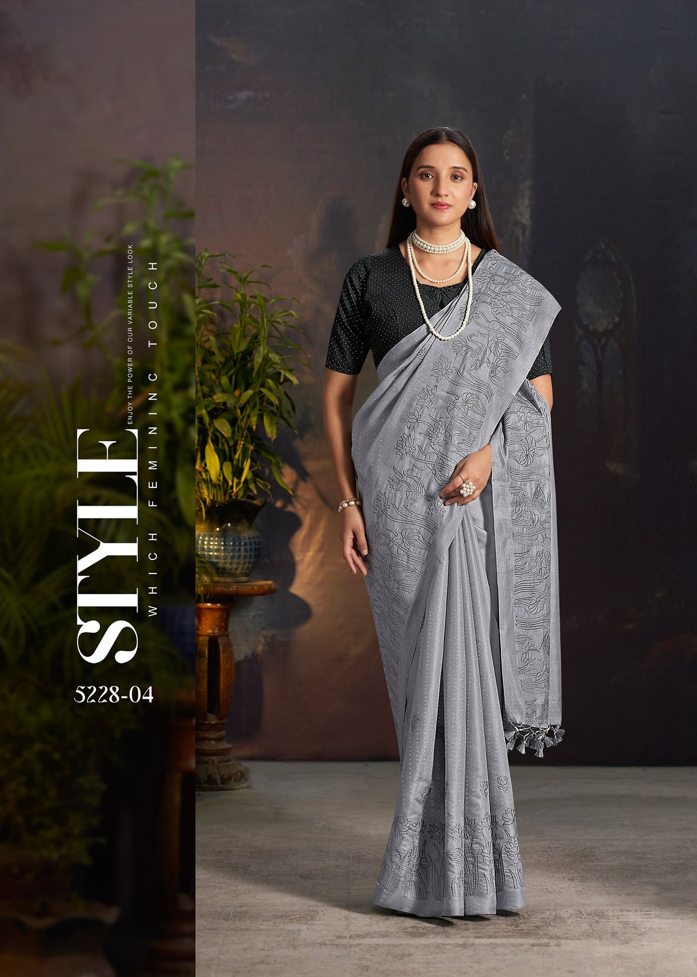 Grey silk saree with subtle woven sheen and embroidered pallu edge