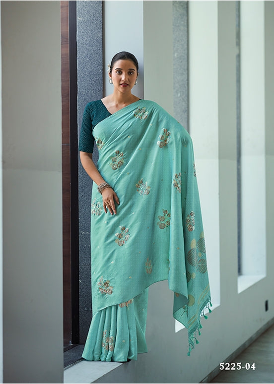 Sea green embroidered saree with matching blouse, small floral motifs and border