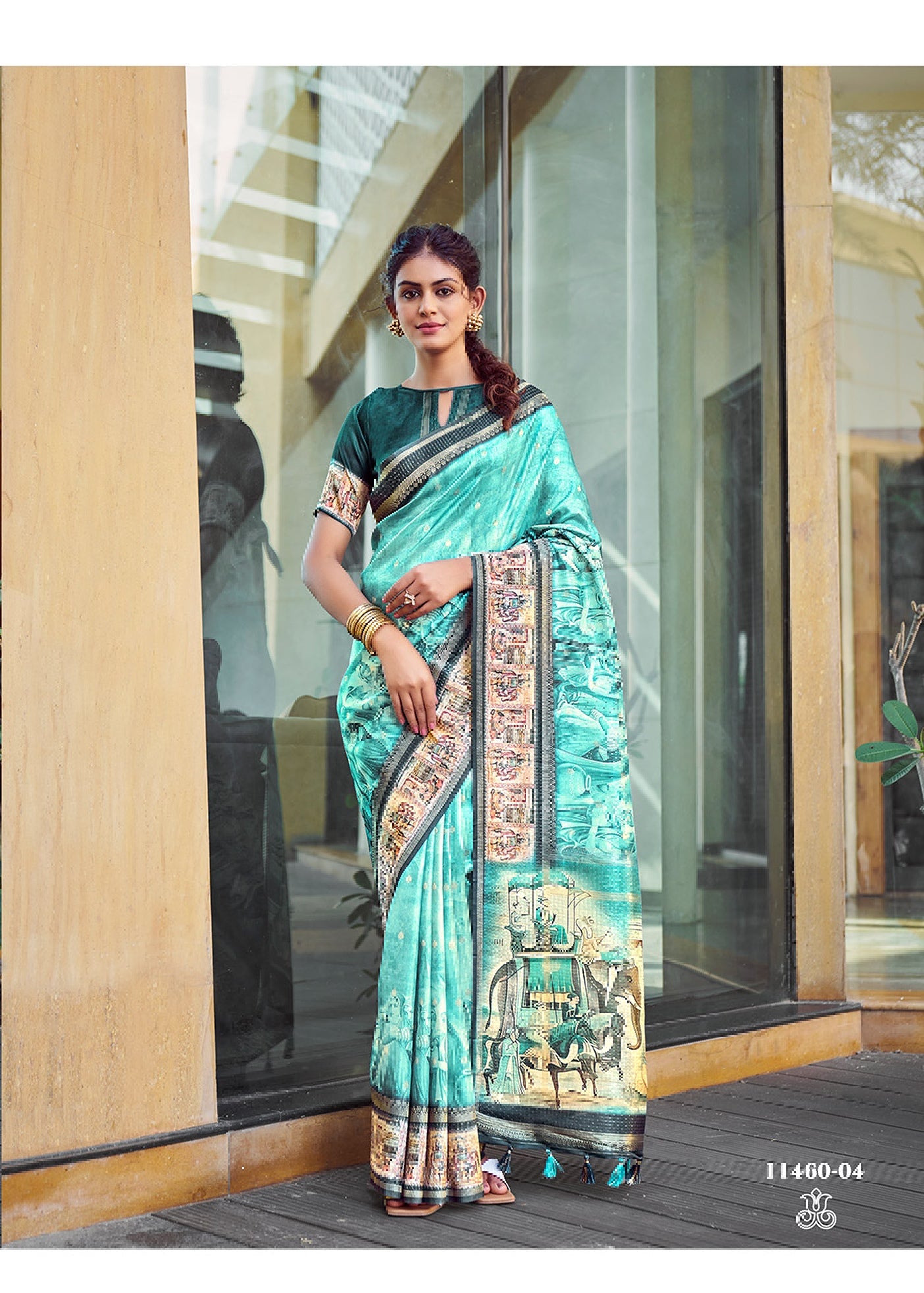 Turquoise silk saree with zari border and Kalamkari mural print, draped pallu