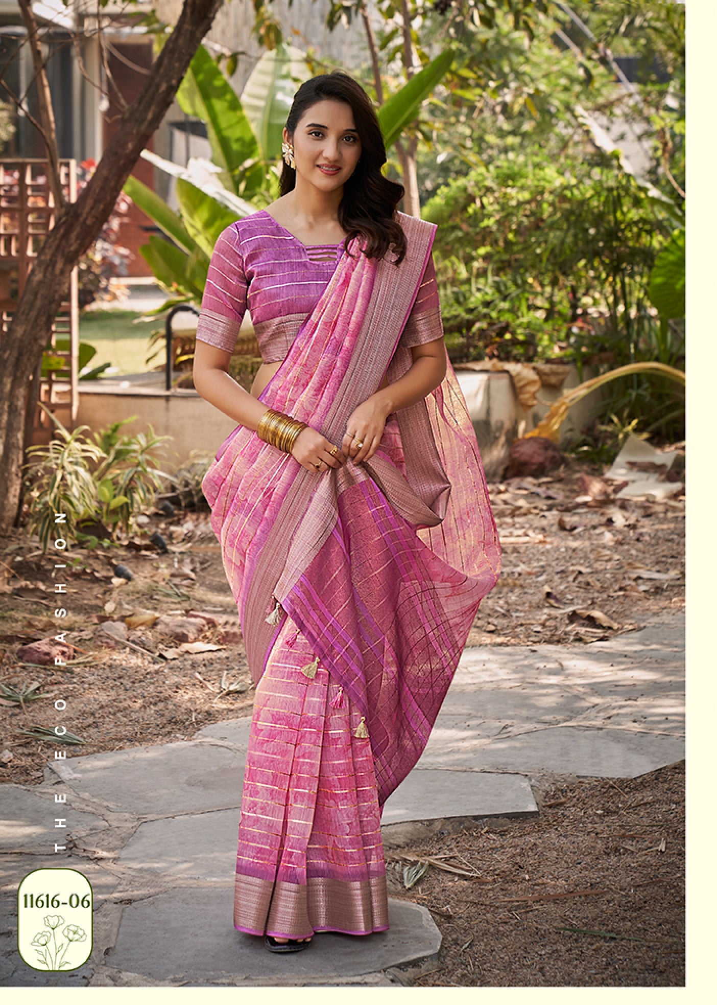 Rose pink watercolor linen saree with muted purple pattern and gold check border, draped