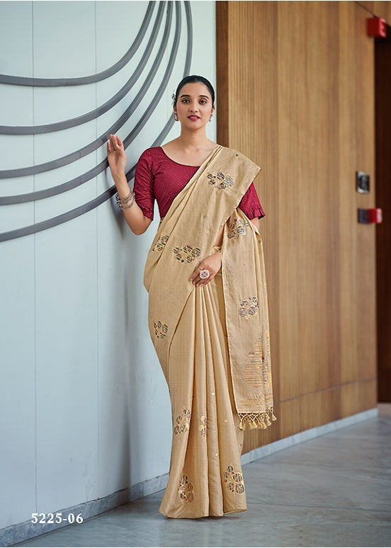 Beige embroidered saree with matching blouse, floral motifs and patterned border