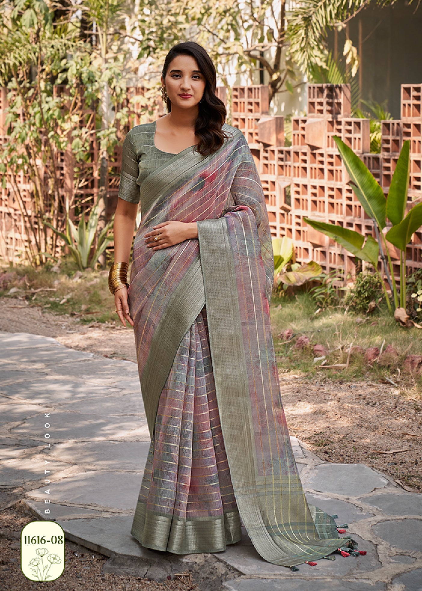 Sage green watercolor linen saree with blue-gray pattern and gold check border, draped