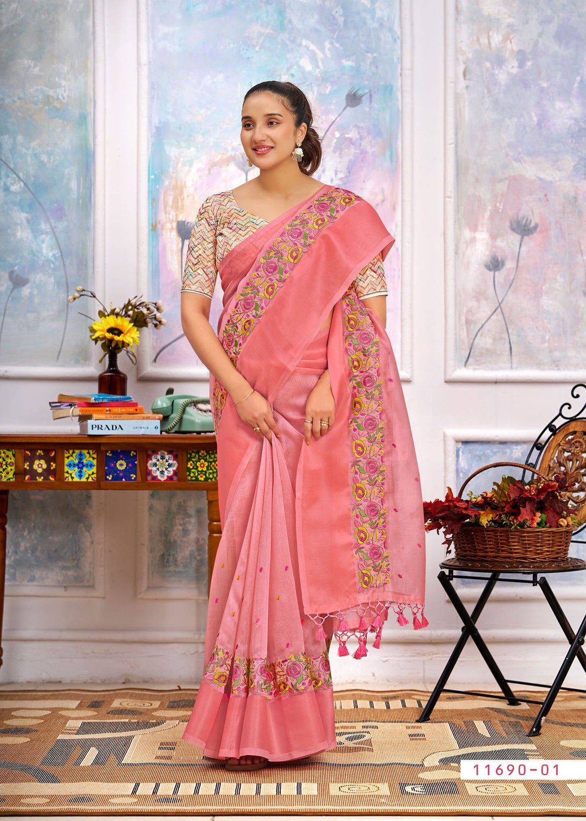 Pink cotton saree with floral border, embroidered pallu drape and tassel ends