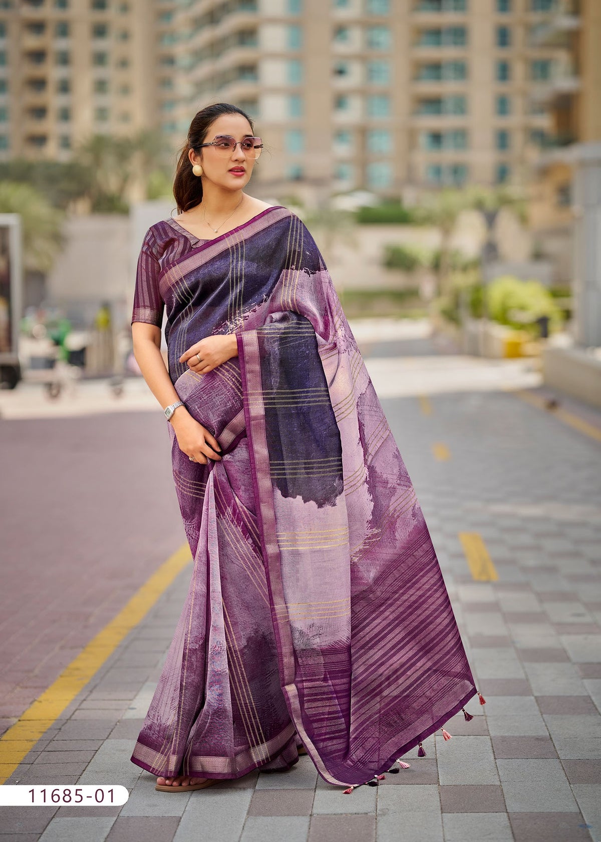 Cotton fancy saree in purple with dark striped pallu and bordered drape.