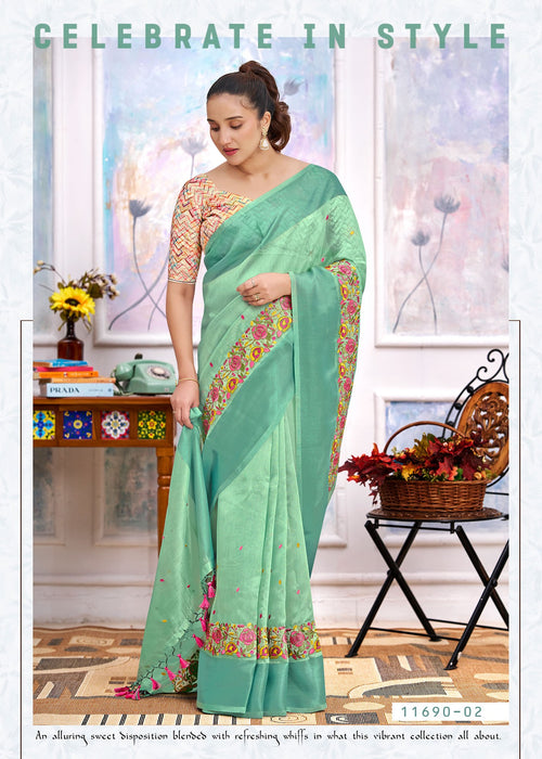 Mint green cotton saree with floral border, embroidered pallu drape and tassel ends