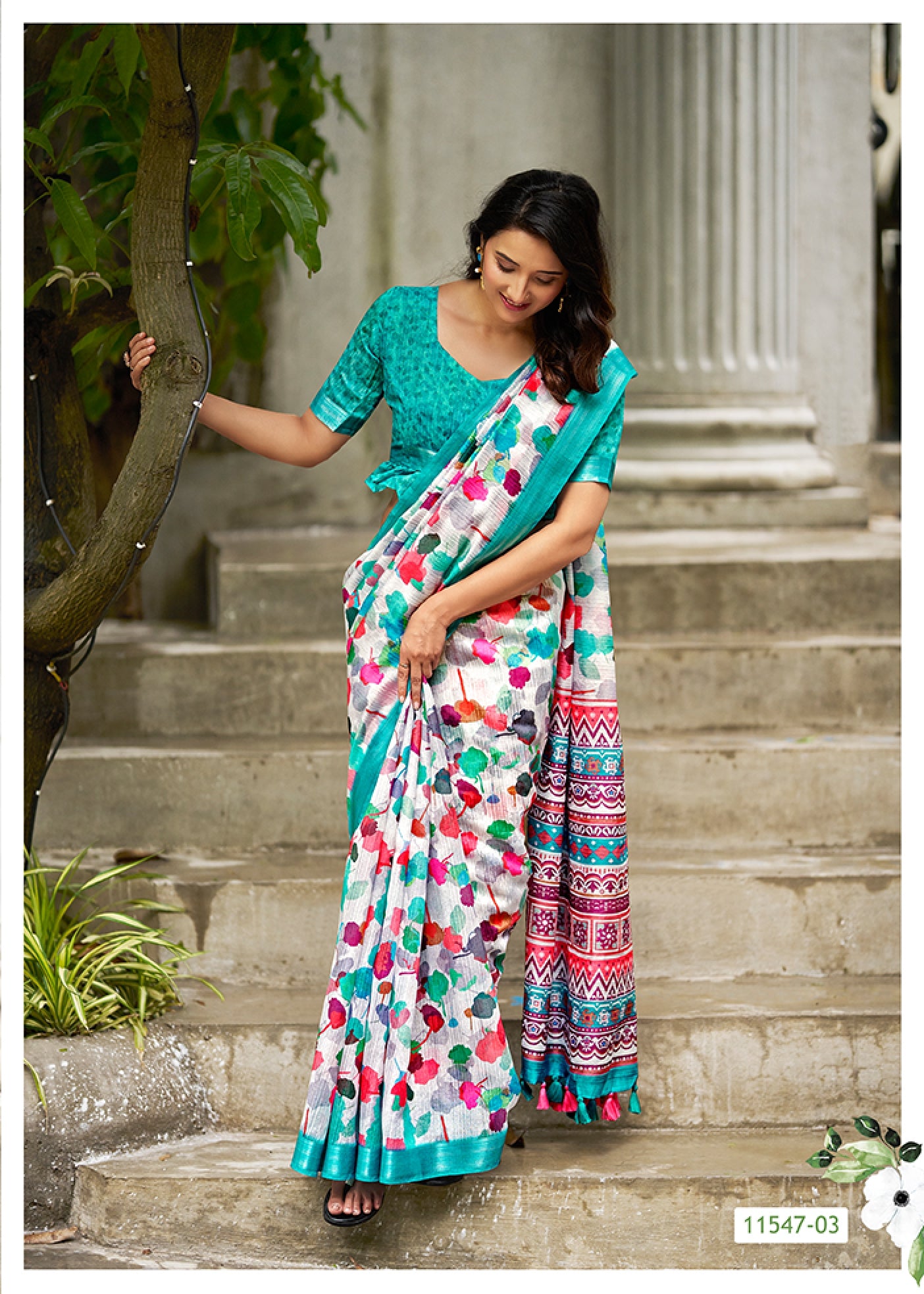 Floral linen saree in teal with contrast border and multicolor printed border trim