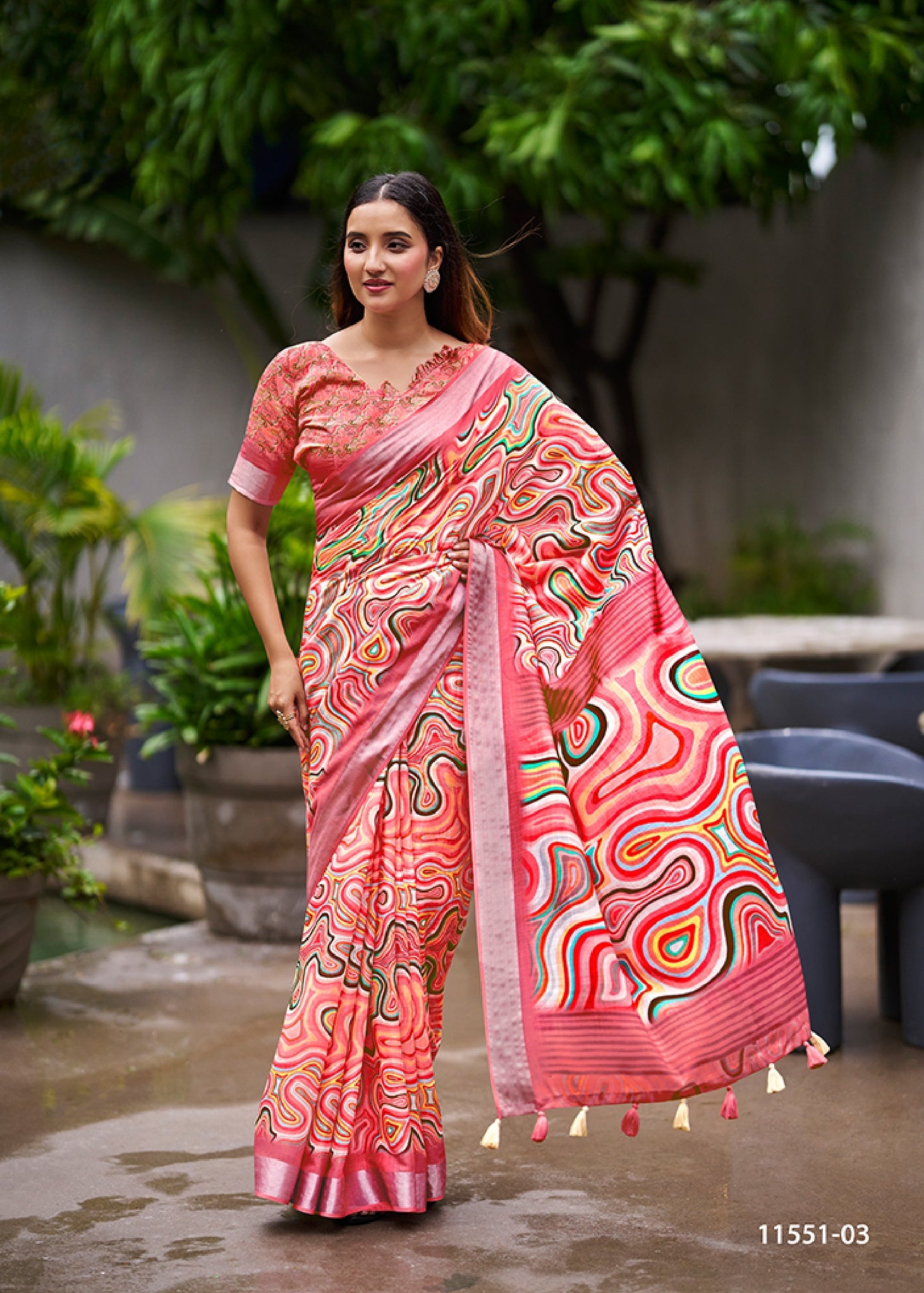 Coral pink abstract swirl print linen saree with dark contrast border and draped pallu