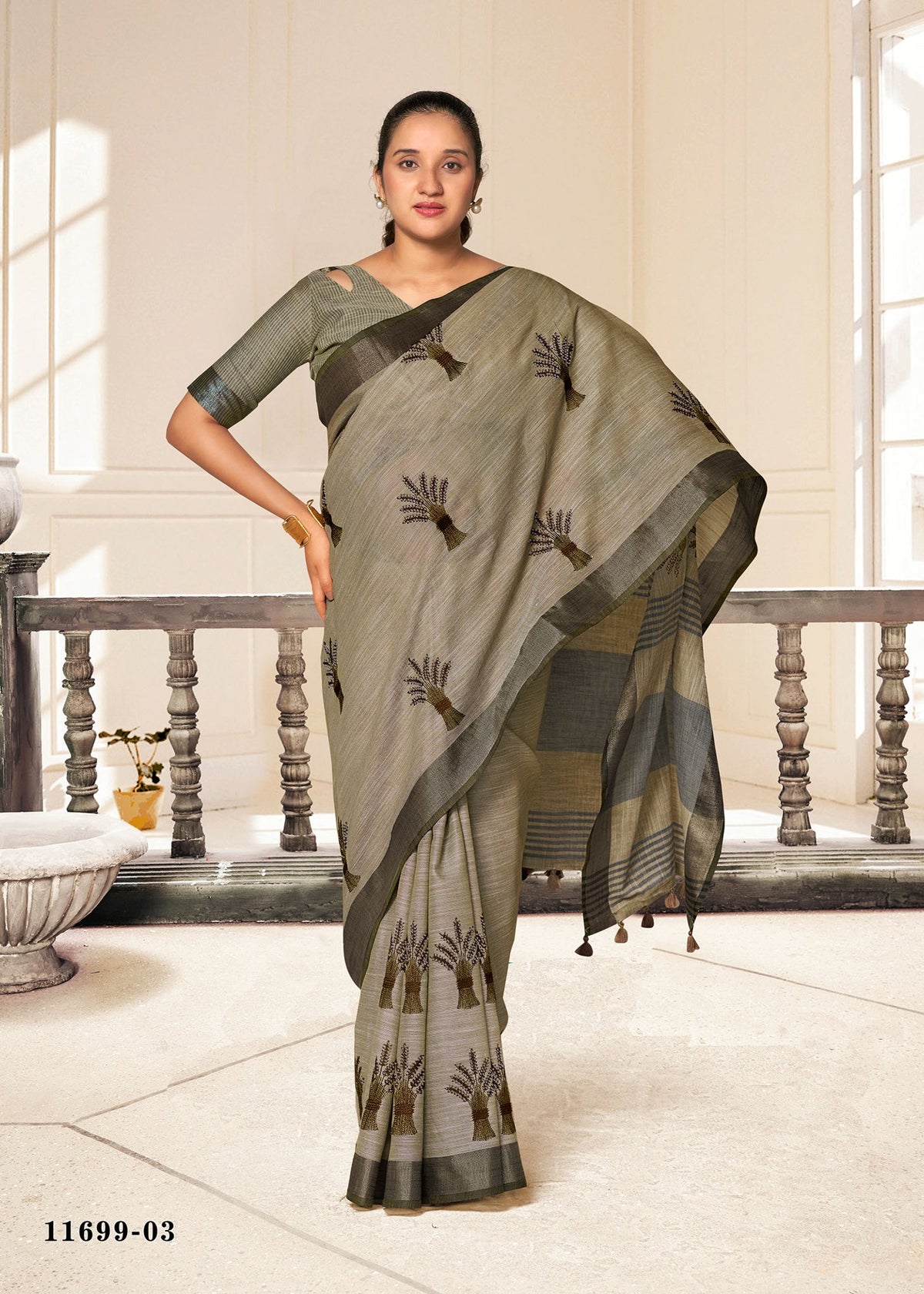 Cotton fancy saree in dark olive with black leaf motifs and gray border.