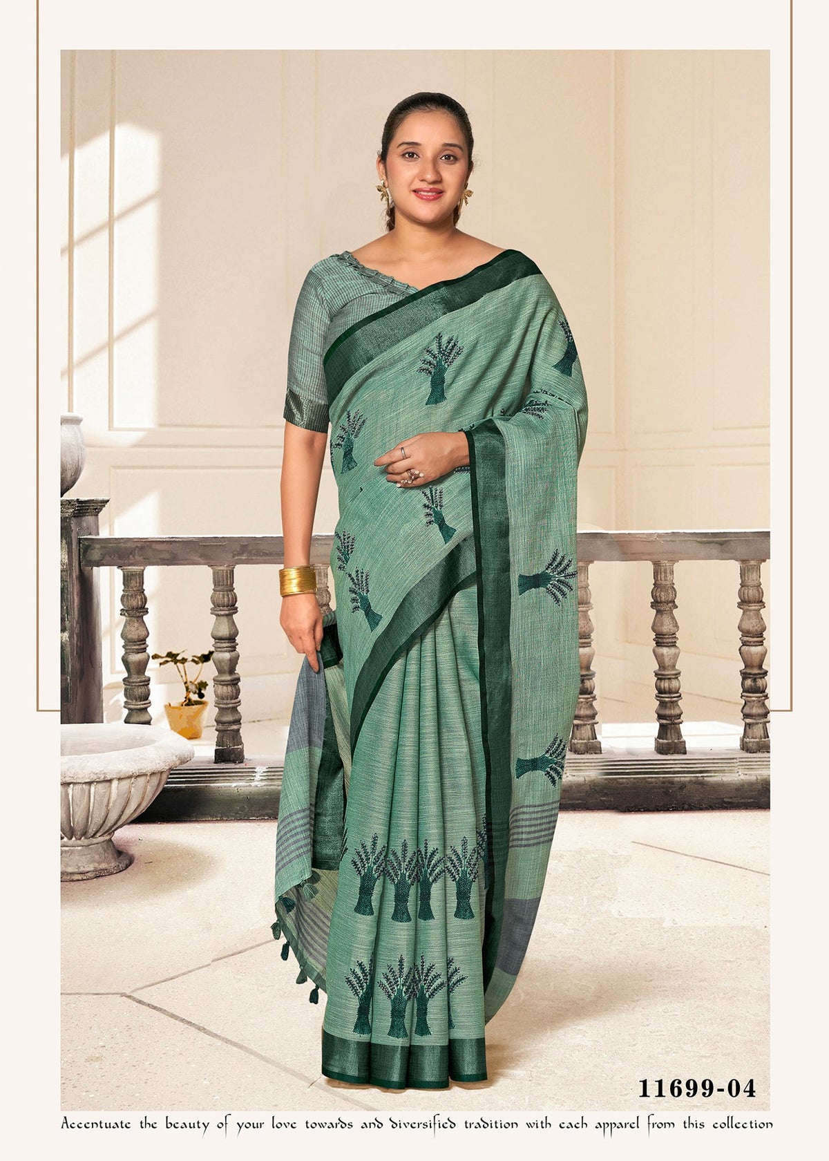 Cotton fancy saree in teal green with dark leaf motifs and fringed edge.