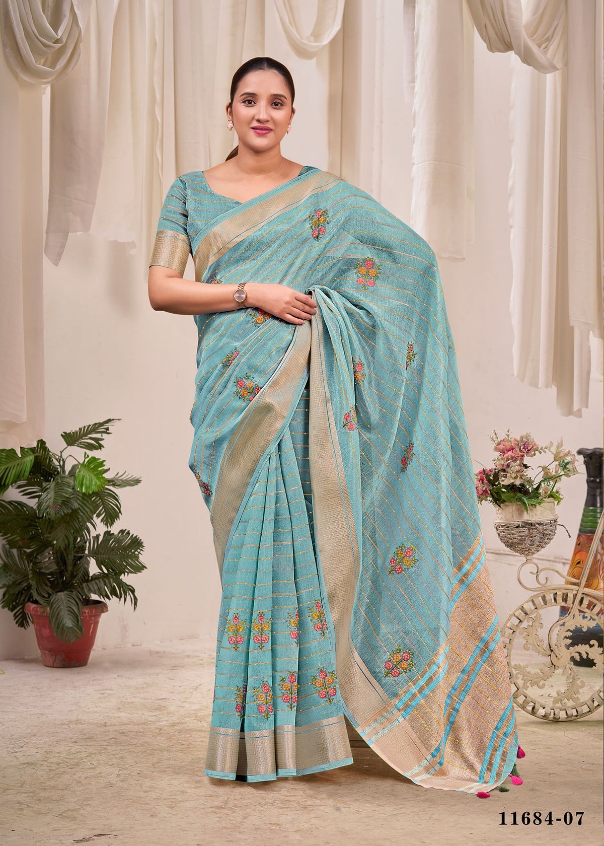 Blue cotton saree with floral print, striped border, and matching pallu