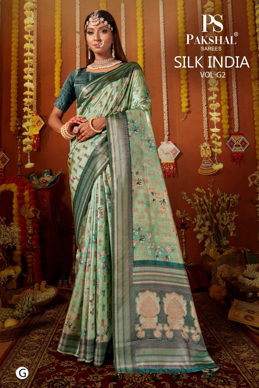Teal silk saree with gold zari border and small floral motifs, draped