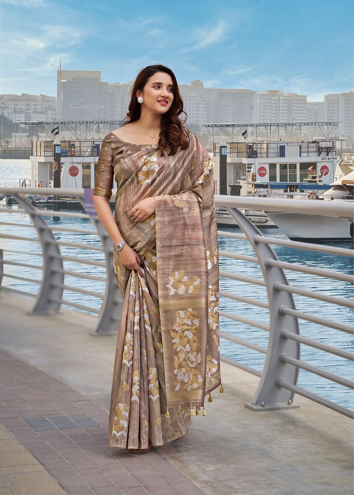 Taupe brown cotton saree with gold floral border and draped pallu