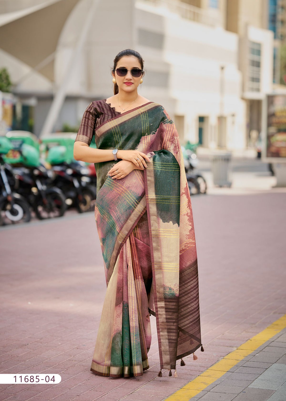 Cotton fancy saree in green with maroon detailing and gold-bordered pallu.
