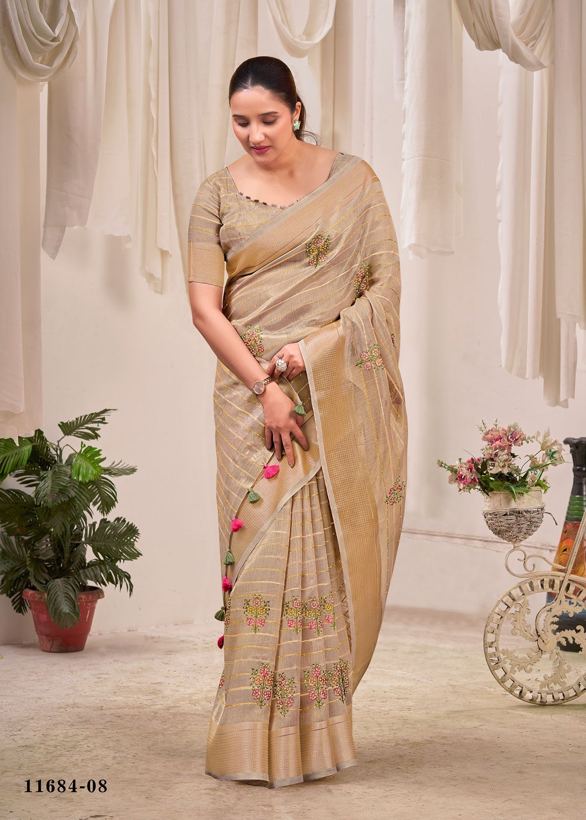 Beige cotton saree with floral print, striped border, and matching pallu