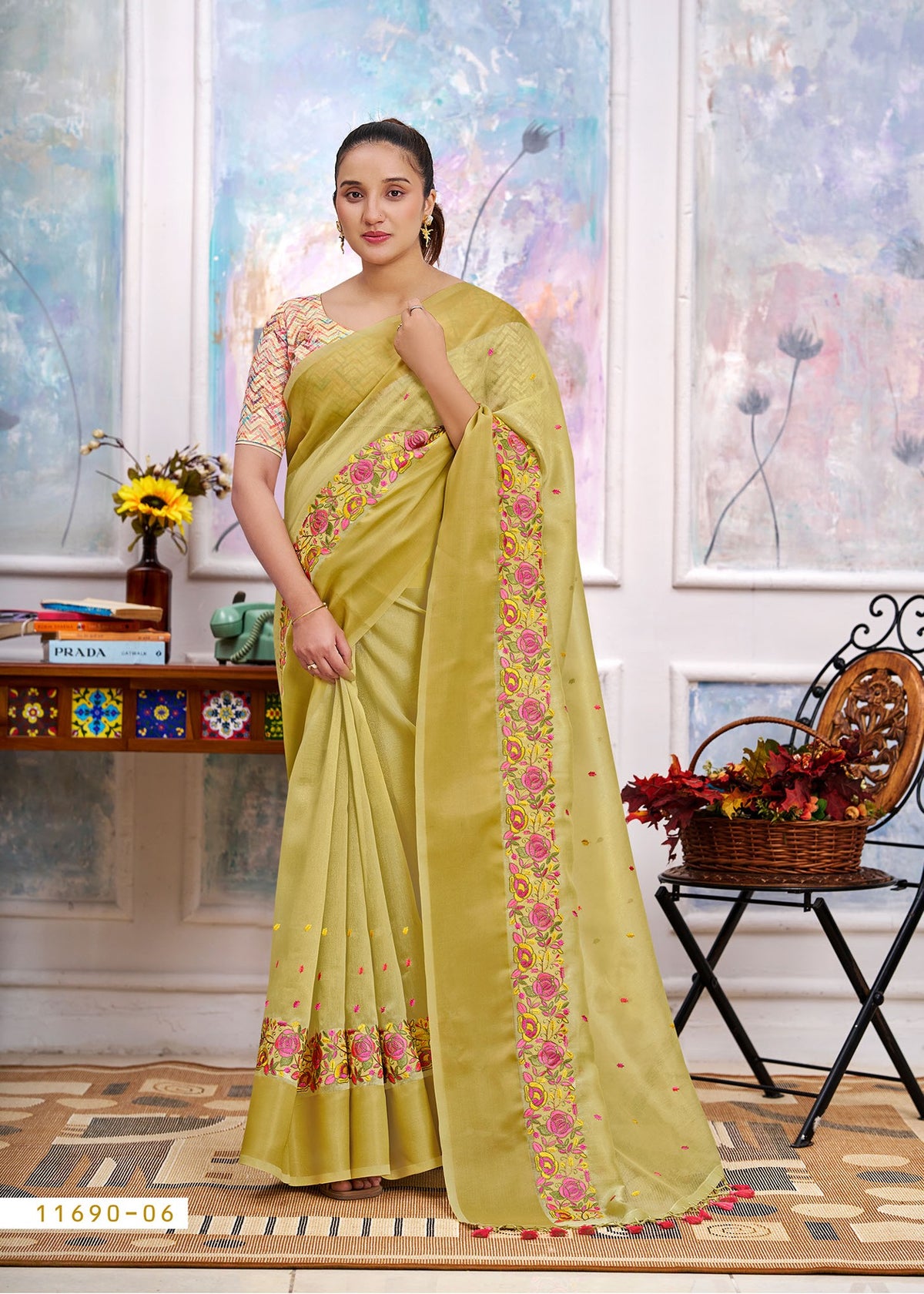 Yellow cotton saree with floral border, embroidered pallu drape and tassel ends