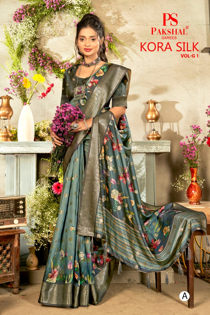 Teal floral silk saree with woven gold border and patterned pallu drape