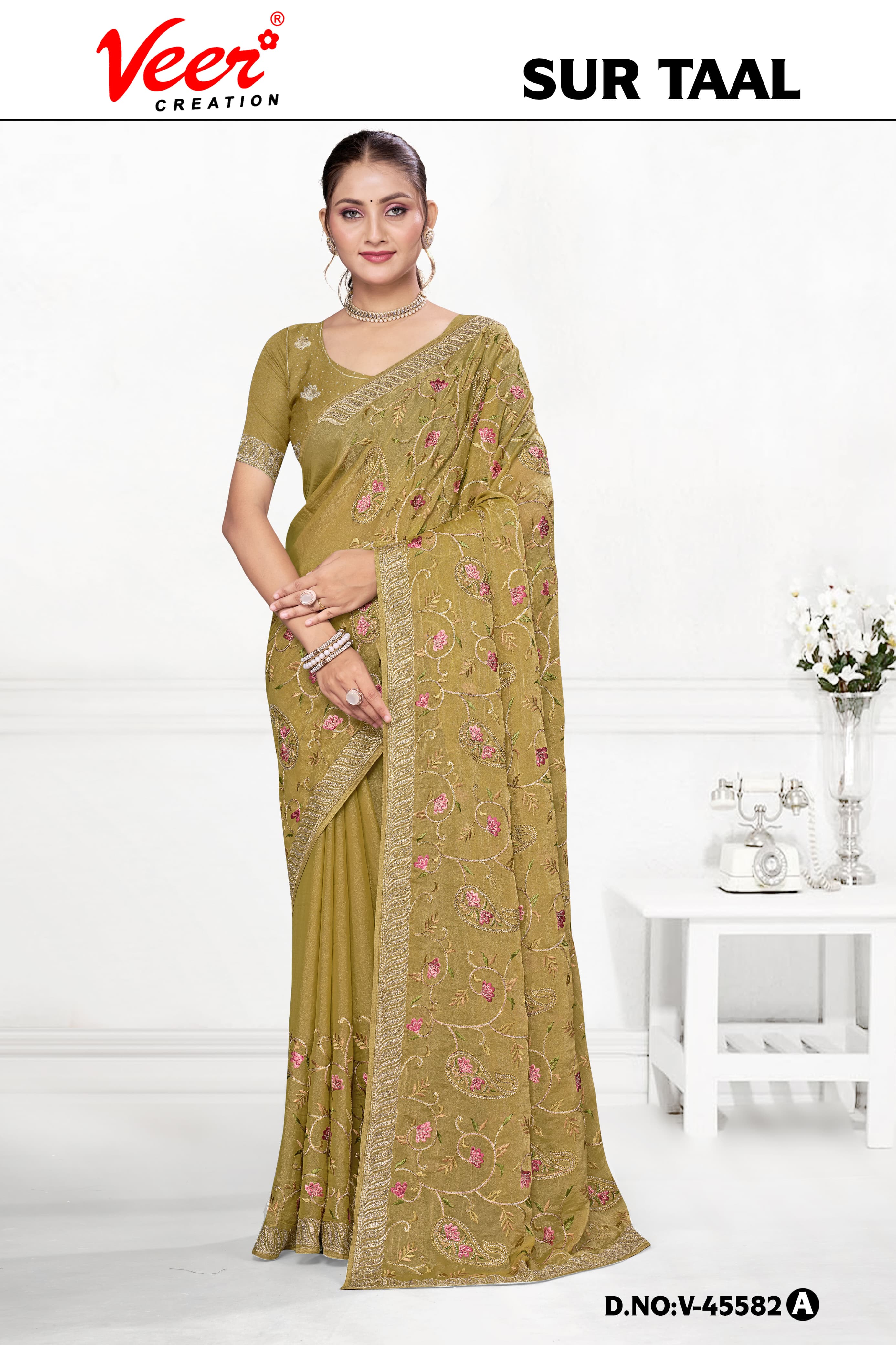 Olive-gold embroidered saree with floral vine motifs and draped pallu