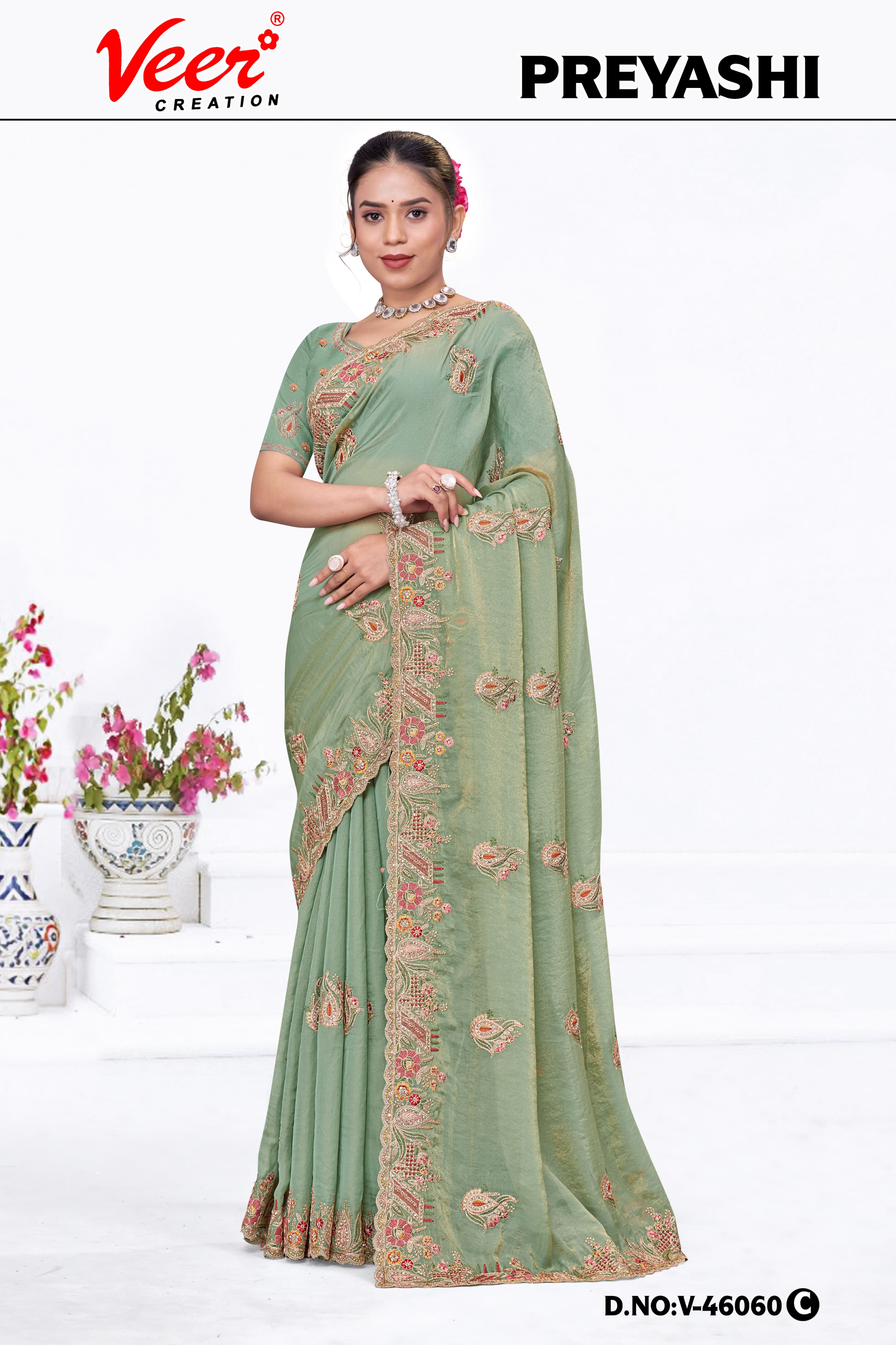 Pastel green embroidered saree with scalloped border and gold-toned floral work