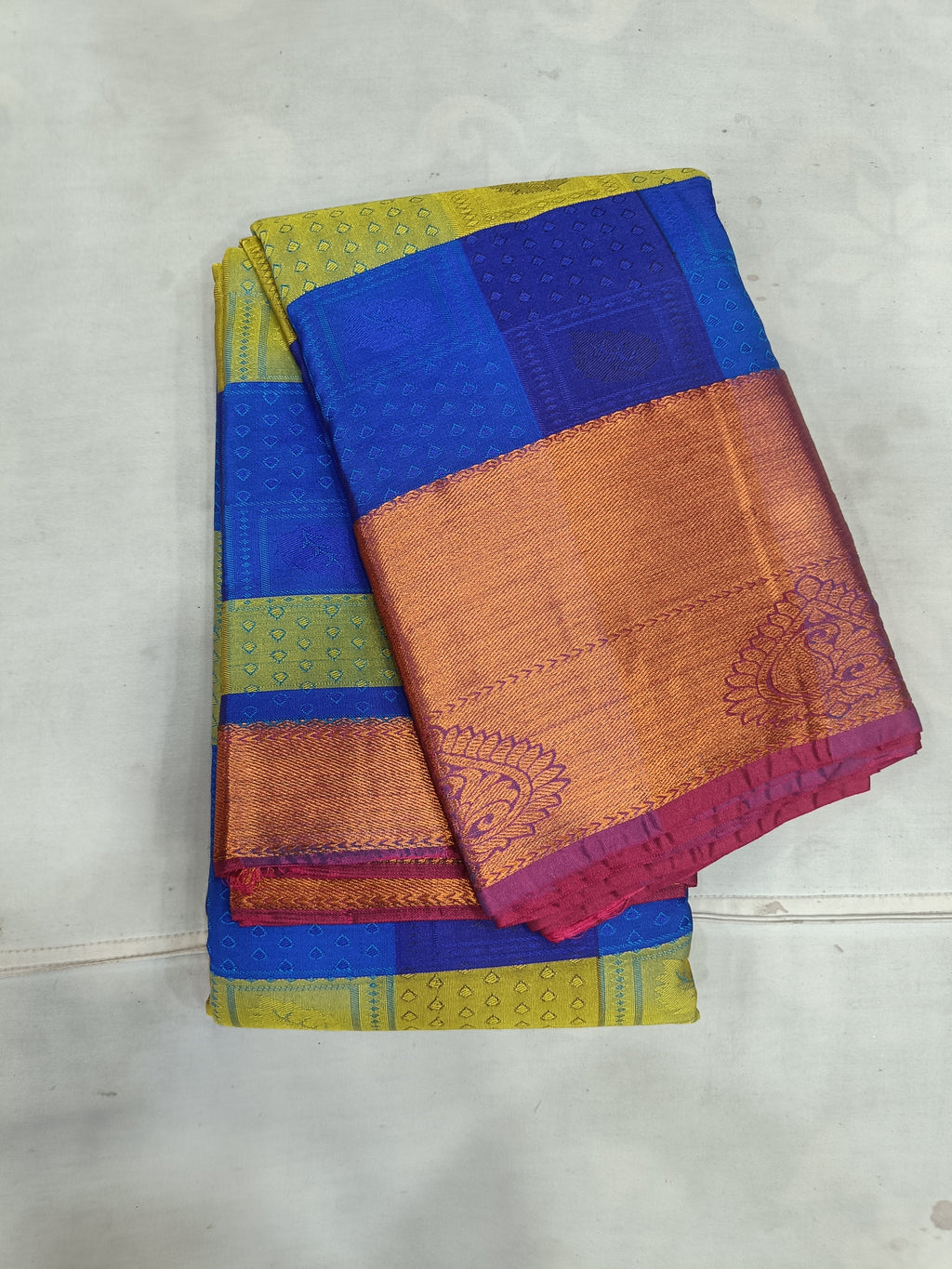 Kanchipuram silk saree in deep blue with yellow-green border and gold-orange pallu