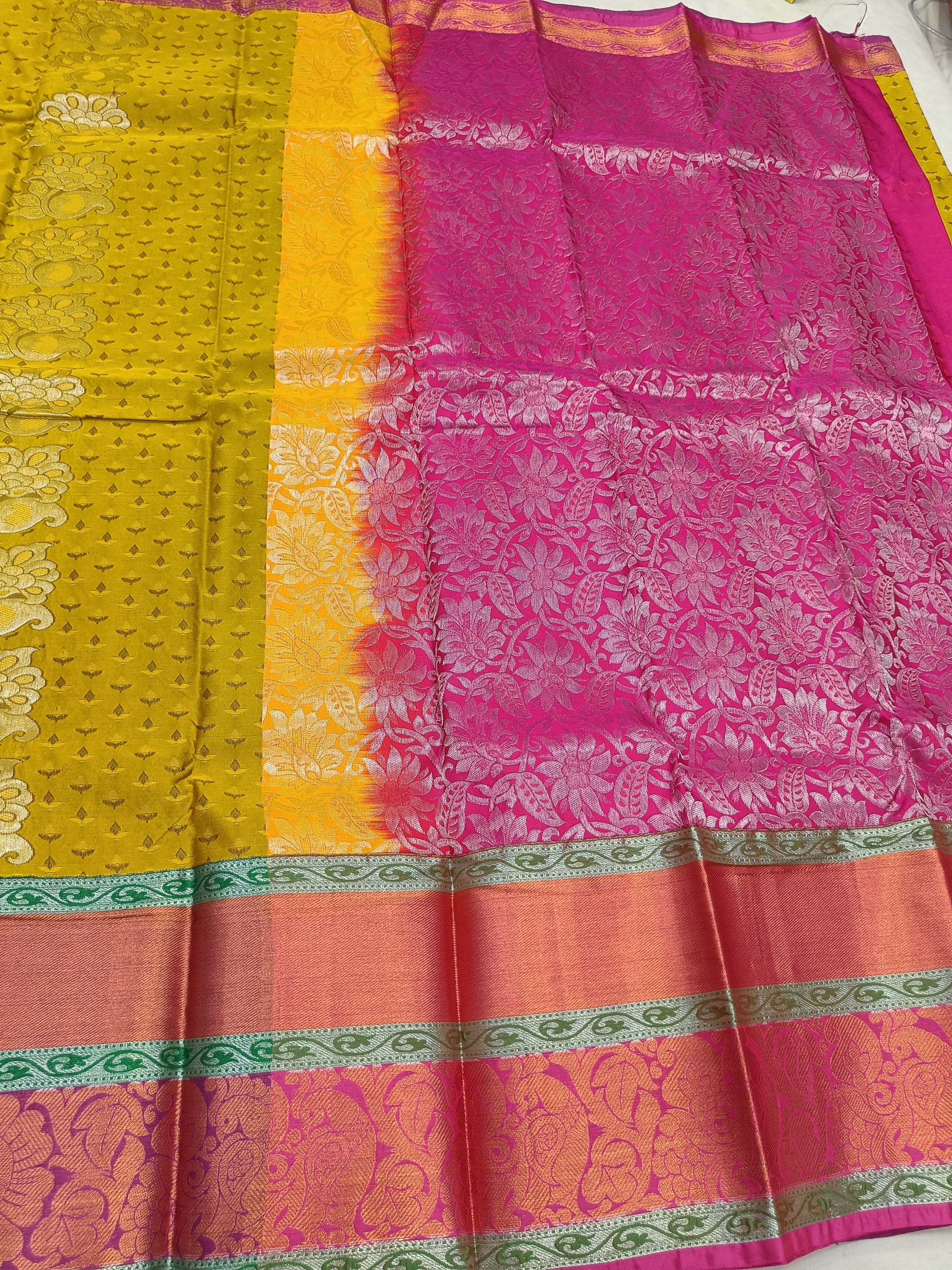 Yellow and pink Kanchipuram silk saree with green border and ornate woven motifs