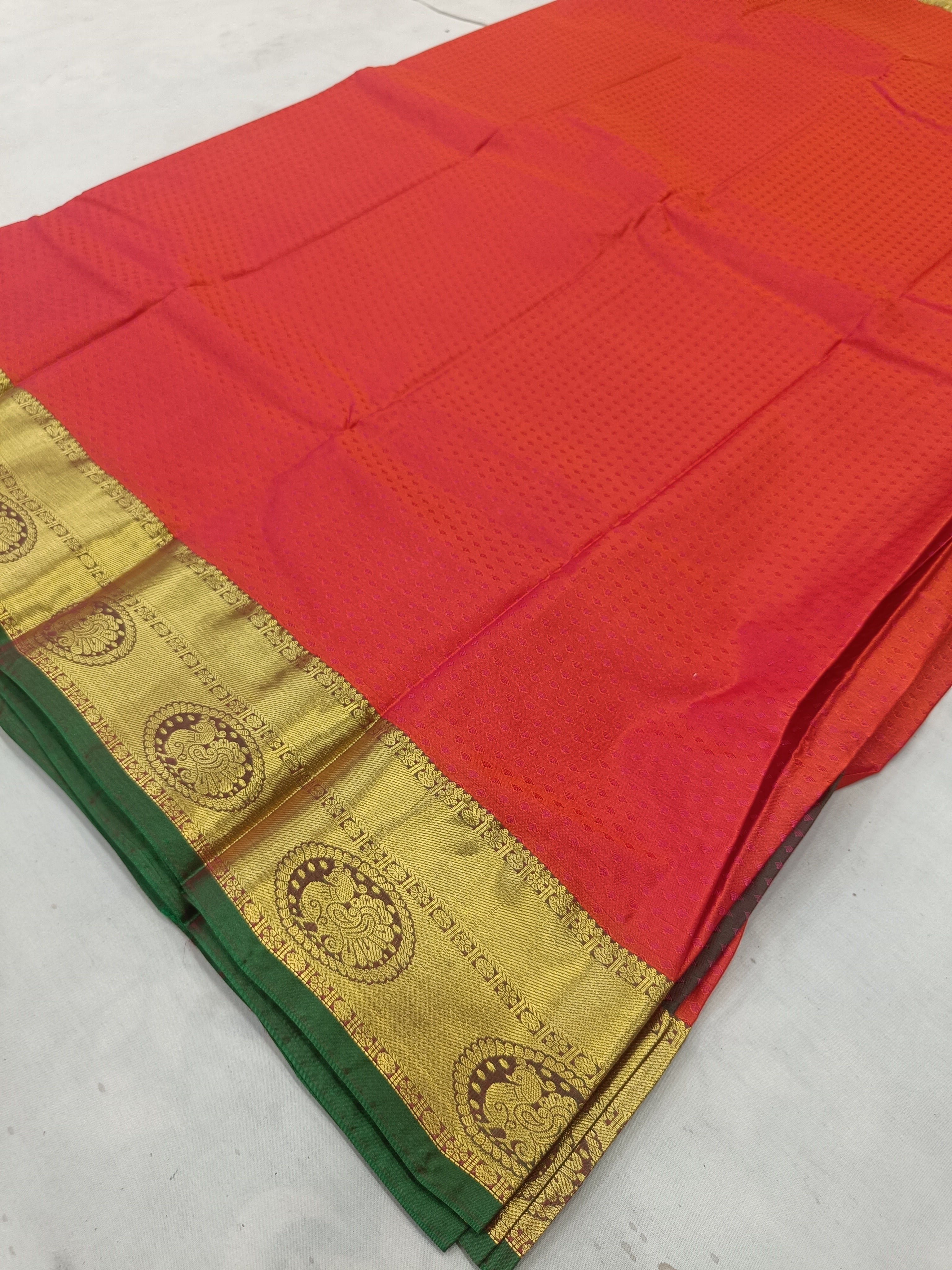 Red silk saree with olive-green edge and gold medallion border