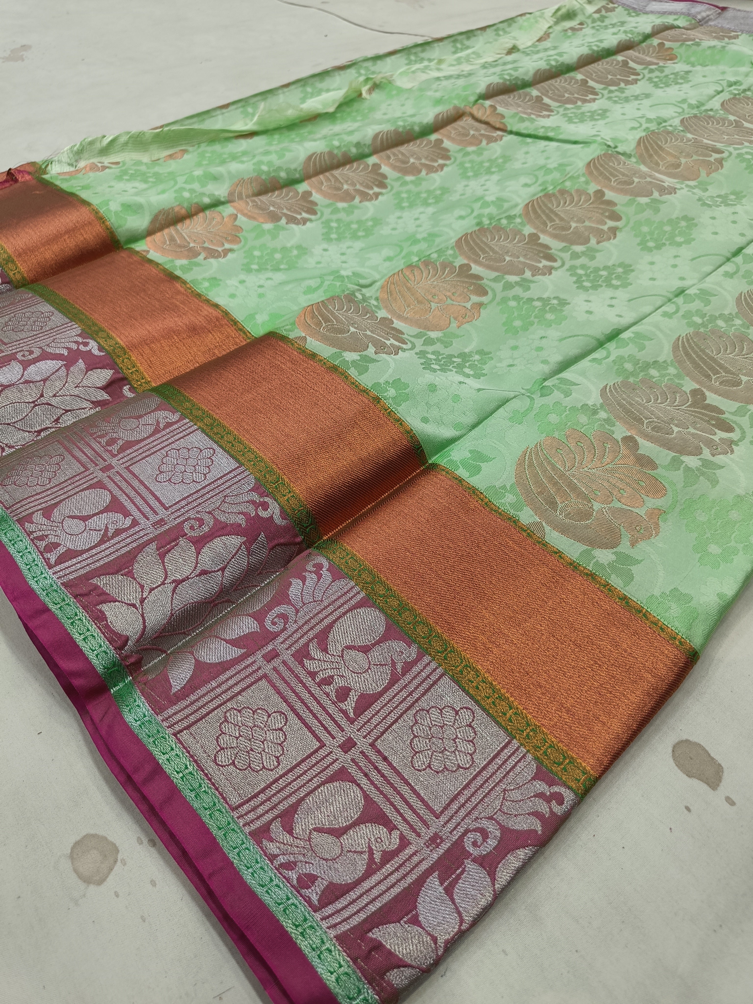Mint green silk saree with bronze-gold border and maroon woven panel