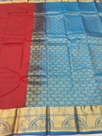 Red and blue silk saree fabric with intricate gold motifs and woven border
