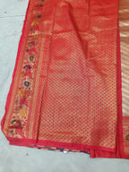 Red Banarasi silk saree section with gold-like woven pattern and floral border