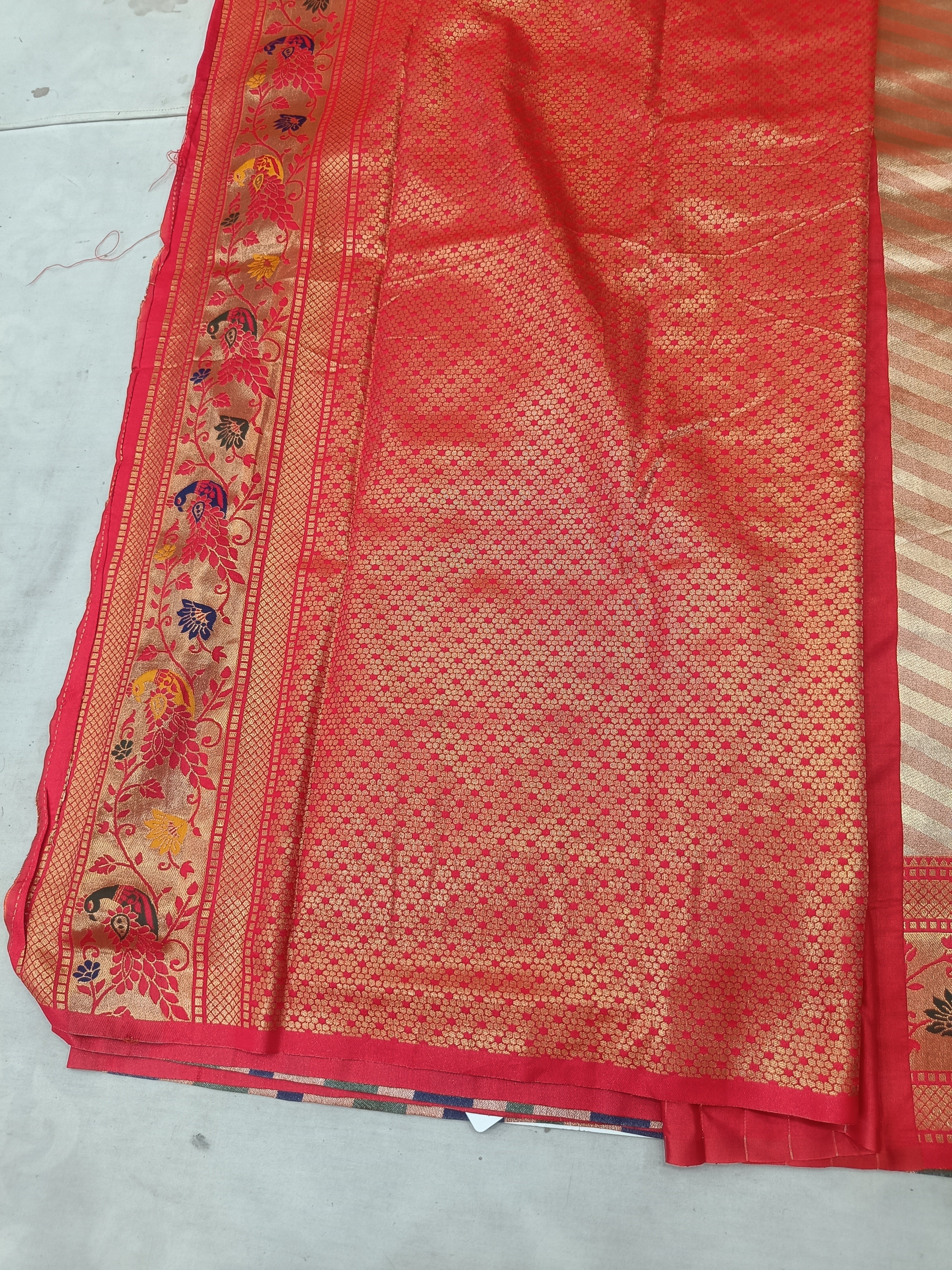 Red Banarasi silk saree section with gold-like woven pattern and floral border