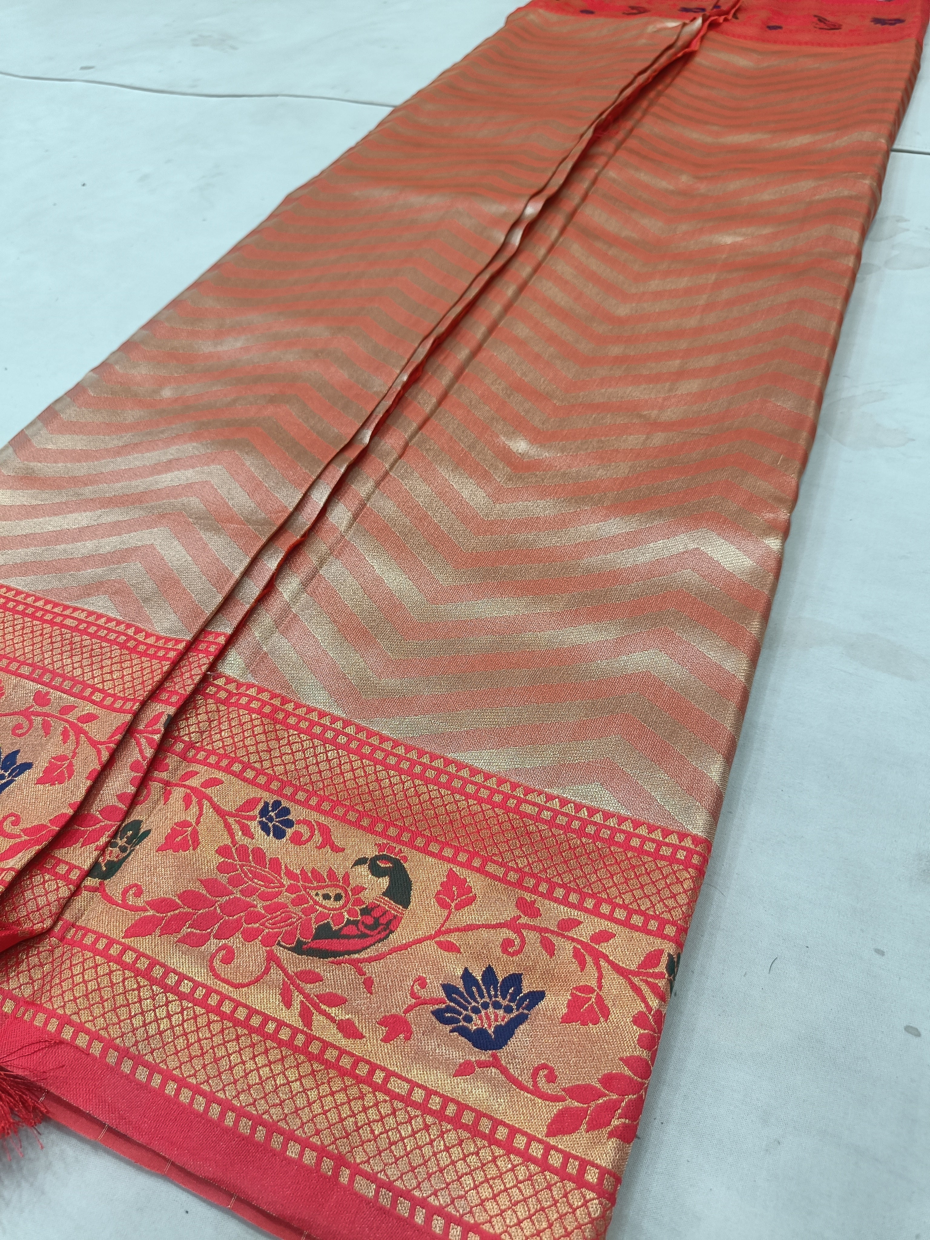 Red and brown Banarasi silk saree with chevron stripes and floral corner border