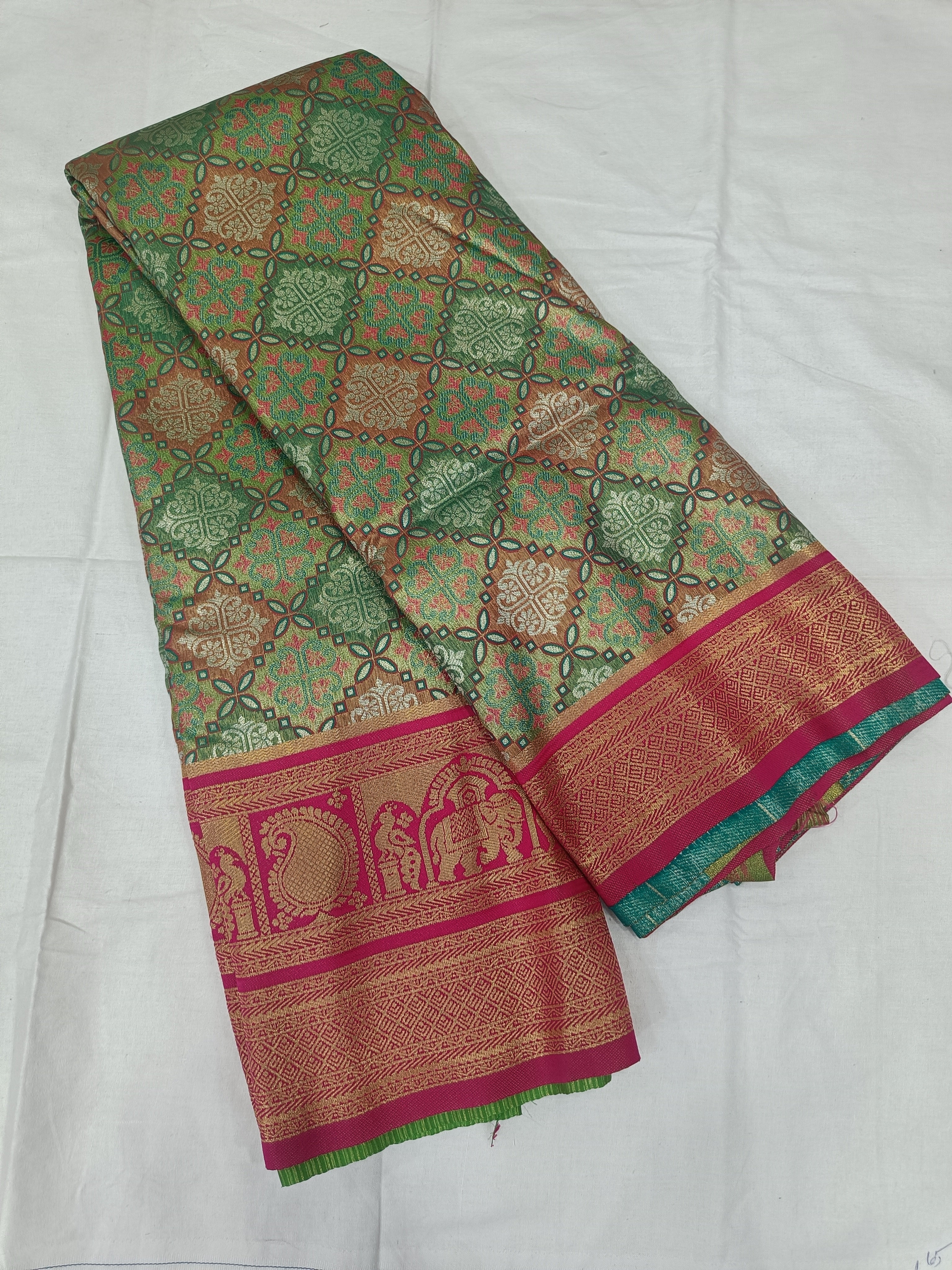Green Banarasi silk saree with small gold floral motifs and magenta border