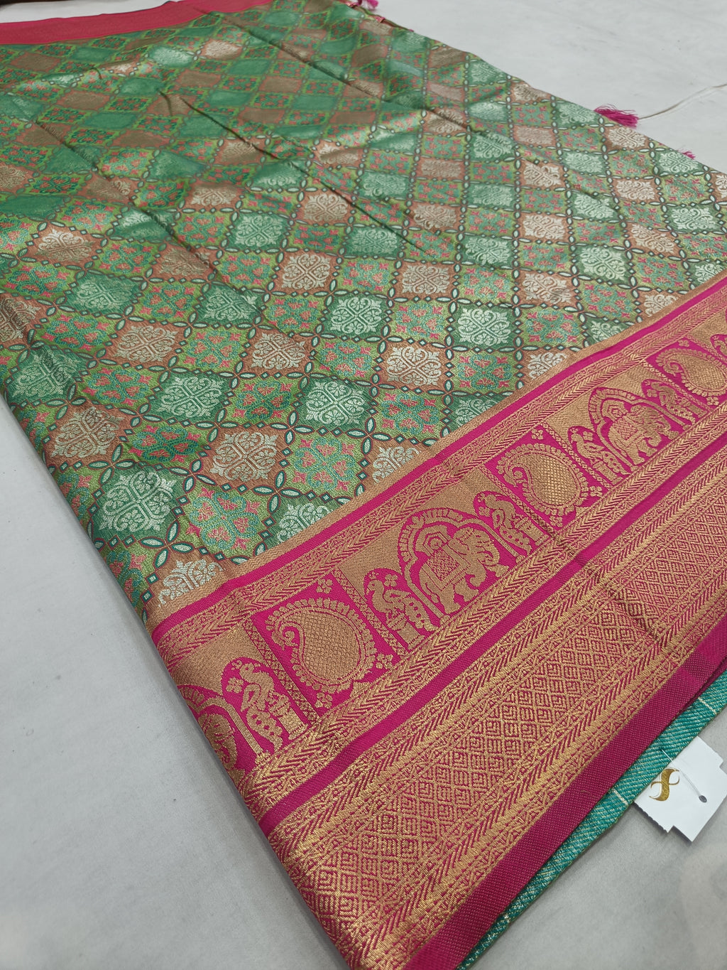 Green patterned Banarasi silk saree with magenta pallu border and gold motifs