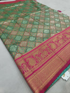 Green patterned Banarasi silk saree with magenta pallu border and gold motifs