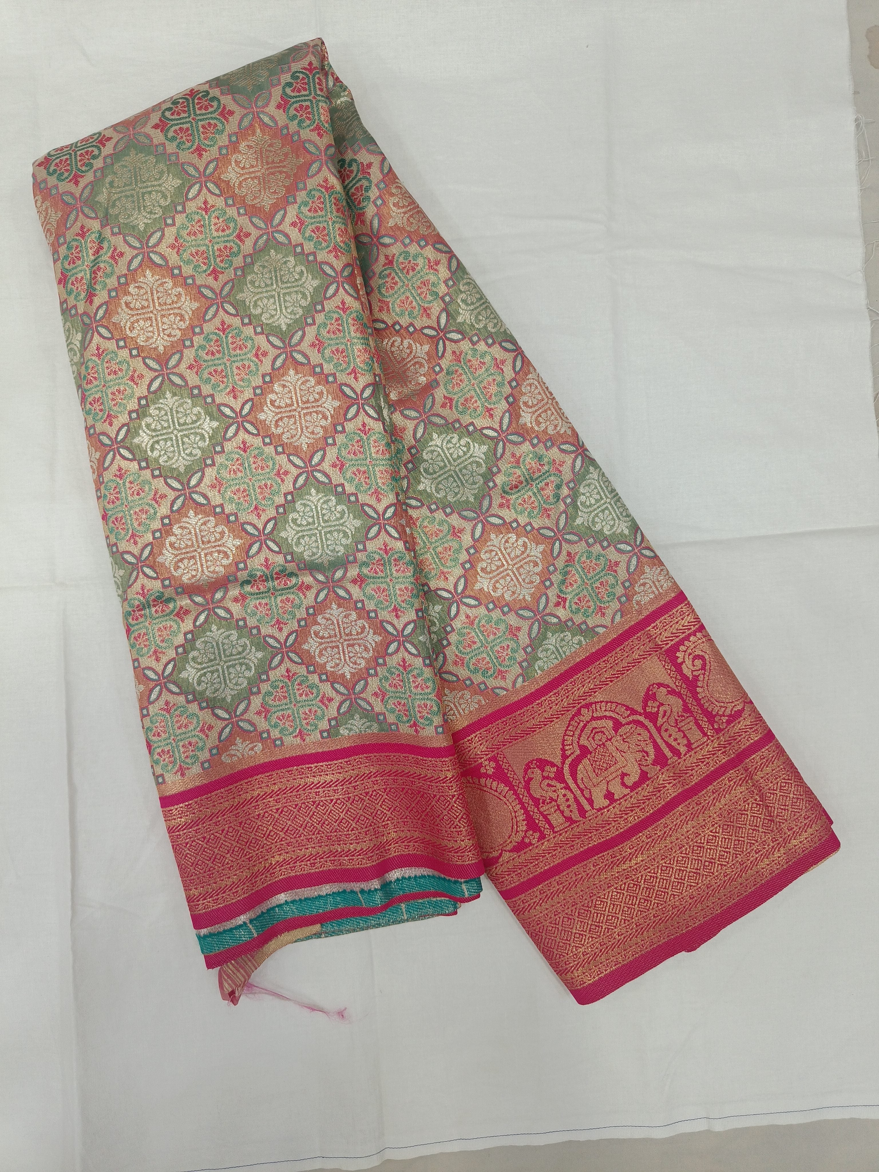 Multicolor silk saree with teal and gold motifs, wide magenta border and unstitched blouse fabric