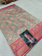 Multicolor silk saree laid flat, geometric motifs and wide magenta zari border