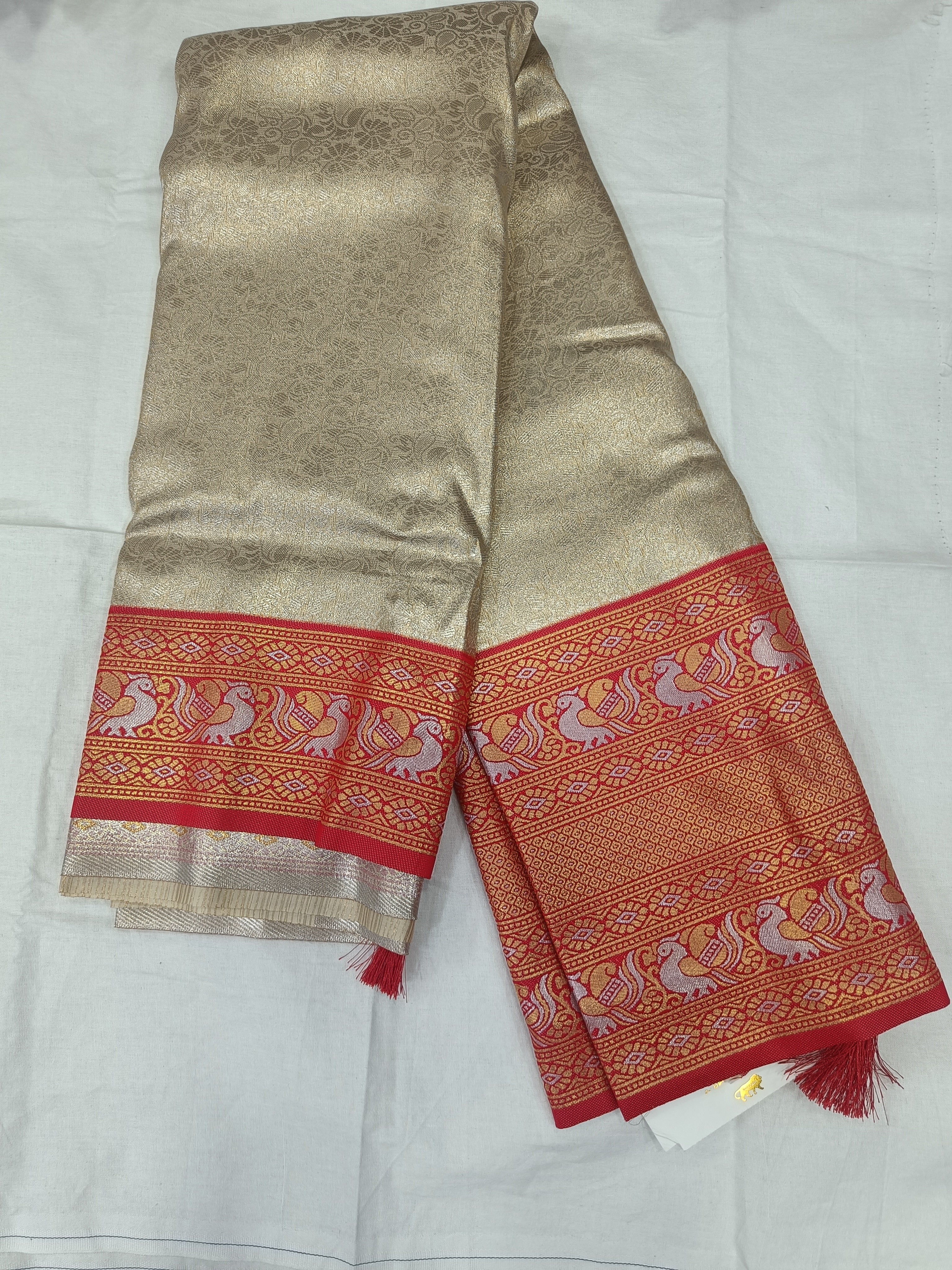 Silver and red Banarasi silk saree with matching unstitched blouse panel and red border