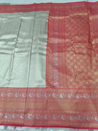 Silver silk saree with red woven border and geometric motifs, flat lay