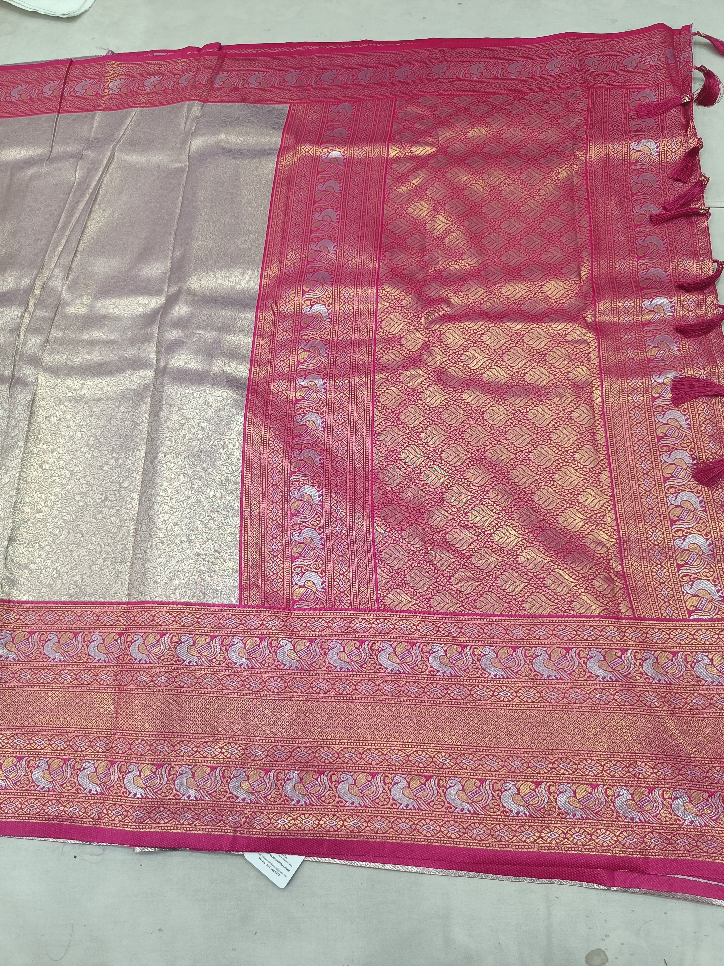 Banarasi silk saree with light grey body, magenta panel, and ornate pink-gold border