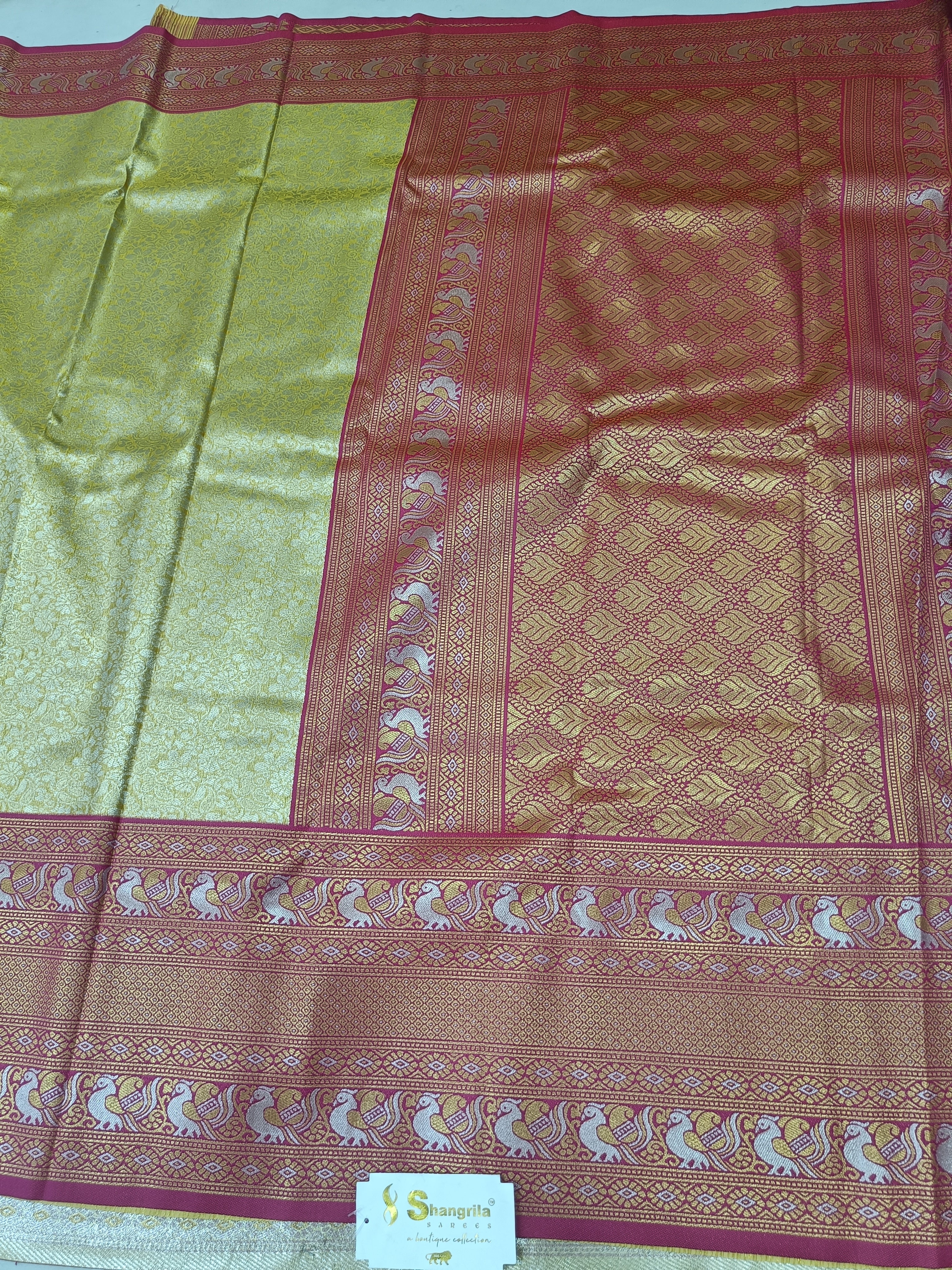 Gold and pink Banarasi silk saree with wide pink border and woven motifs