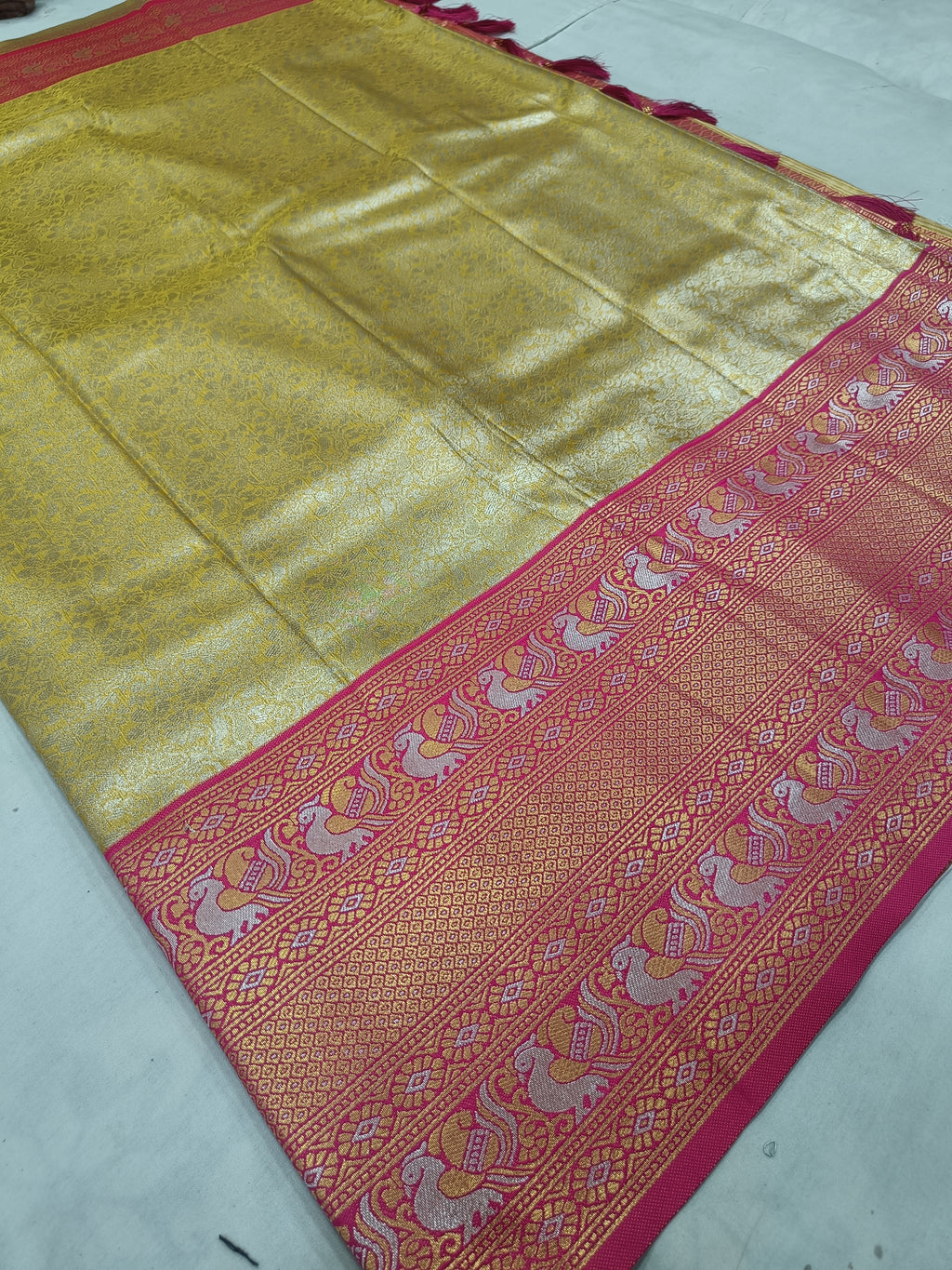 Gold Banarasi silk saree with pink patterned border and detailed woven stripe