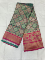 Teal green and pink Banarasi silk saree fabric with geometric motifs and gold border