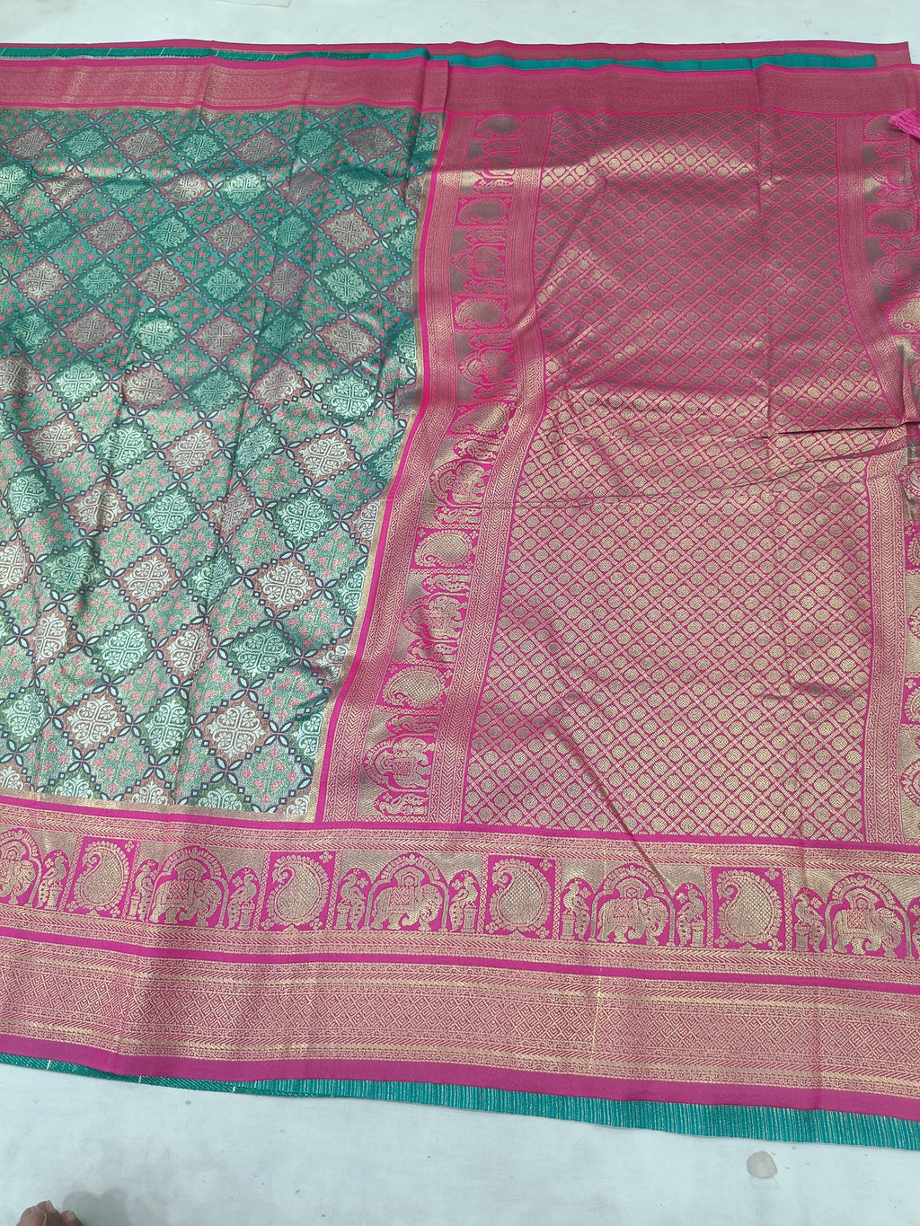 Teal green Banarasi silk saree border detail with pink panel and patterned weave