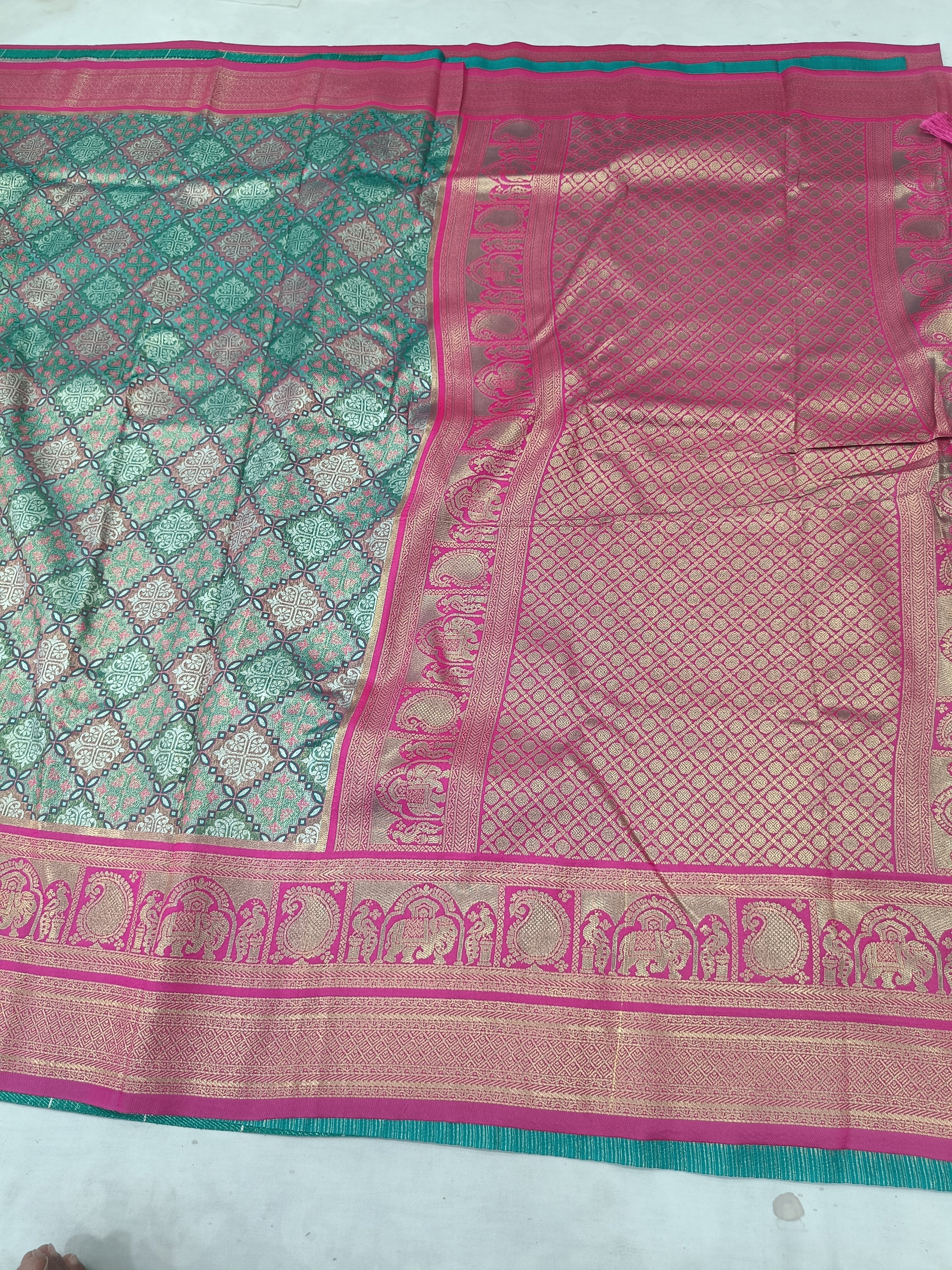 Teal green Banarasi silk saree border detail with pink panel and patterned weave