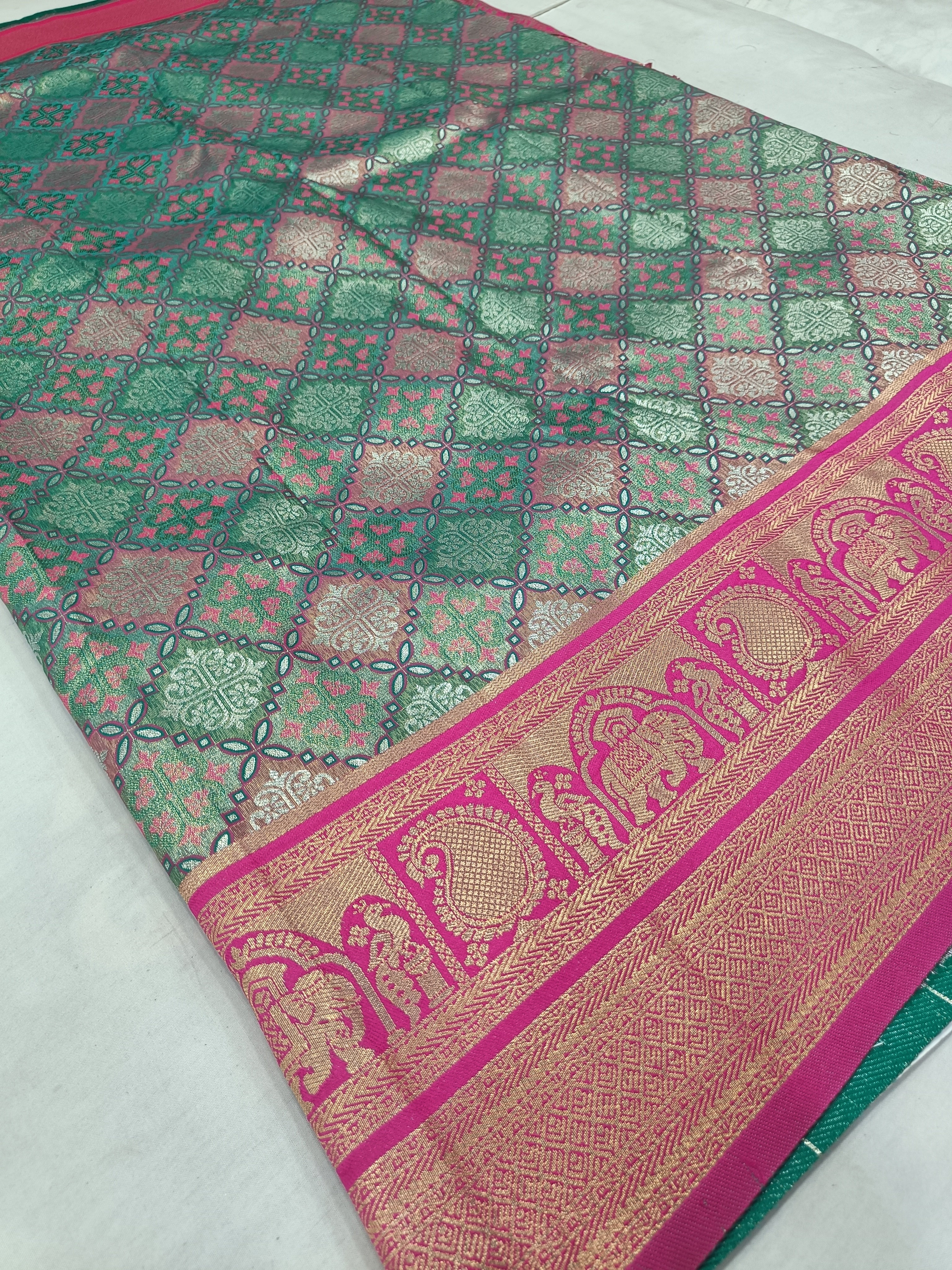 Teal green Banarasi silk saree with pink patterned border and woven lattice motifs