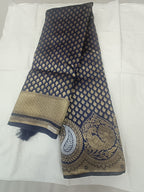 Folded navy blue Banarasi silk saree with gold motif body and ornate border hem