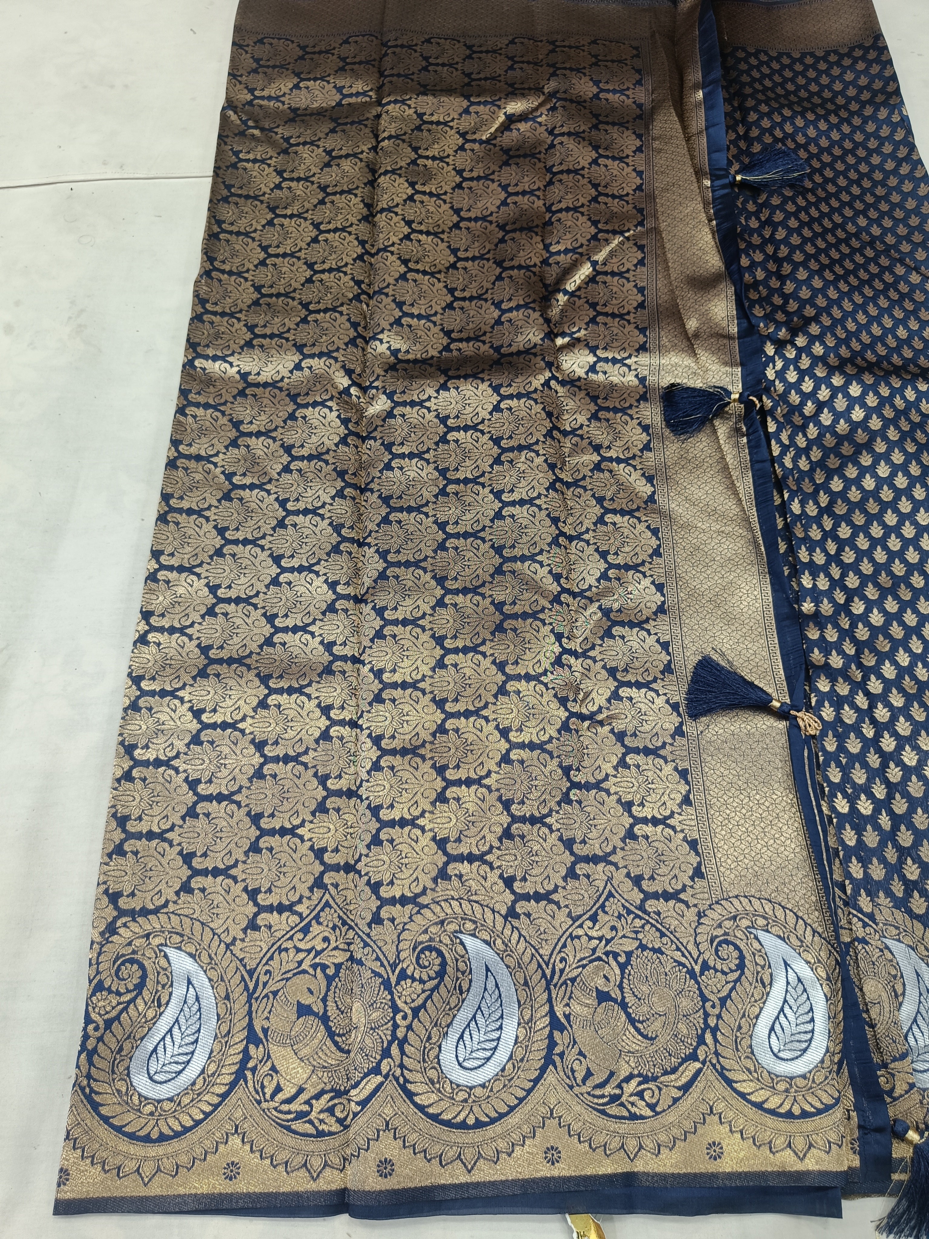 Navy blue saree fabric with gold lattice motifs and wide cream-gold border section